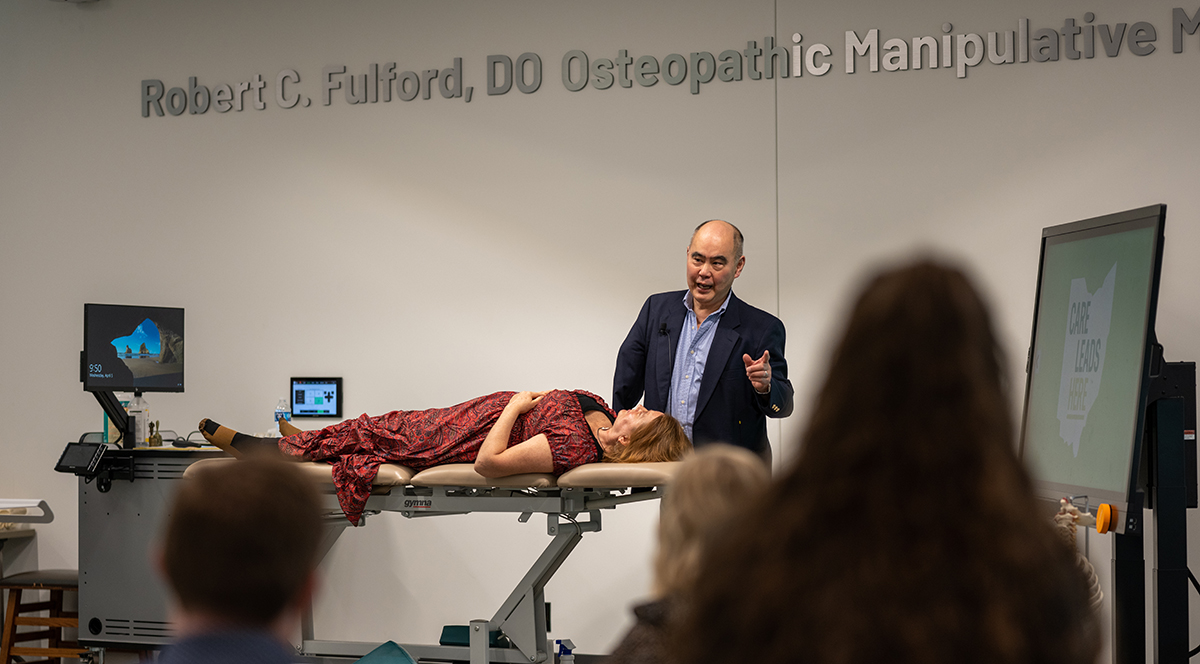 Dr. Andrew Yuan presents in a classroom