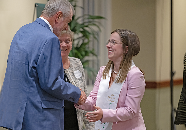 Senior members of the Wandell Student organization receive their sash and pin at the Wandell Fellow Naming Ceremony