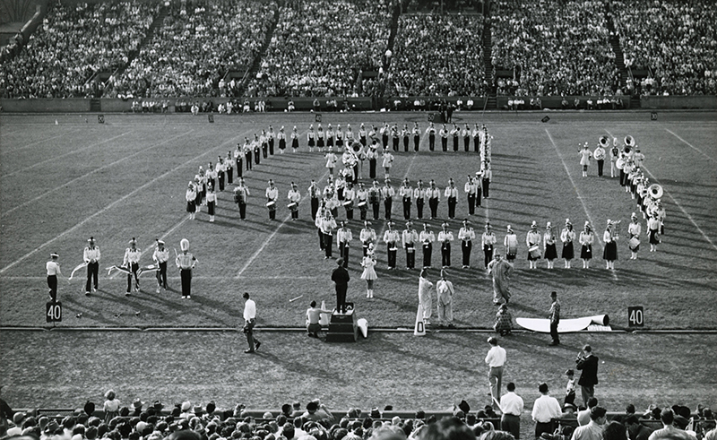 Archival image of the Marching 110 members forming "OU" on the football field