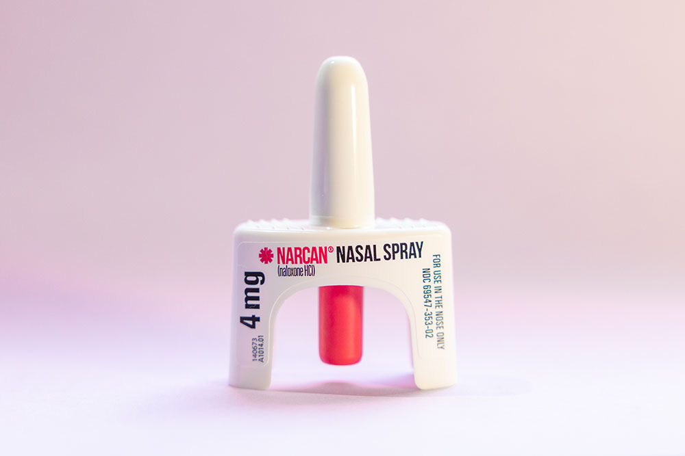 4mg intranasal dose of naloxone on a light pink background