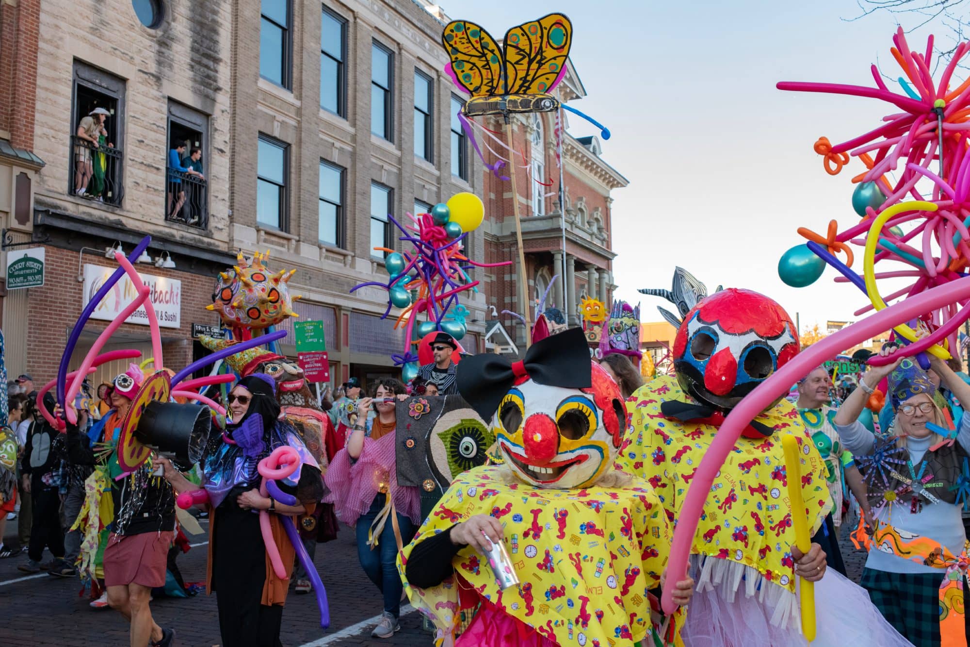 Participants in the 2022 Honey for the Heart parade dance, play music and walk down Court Street in Athens, Ohio.