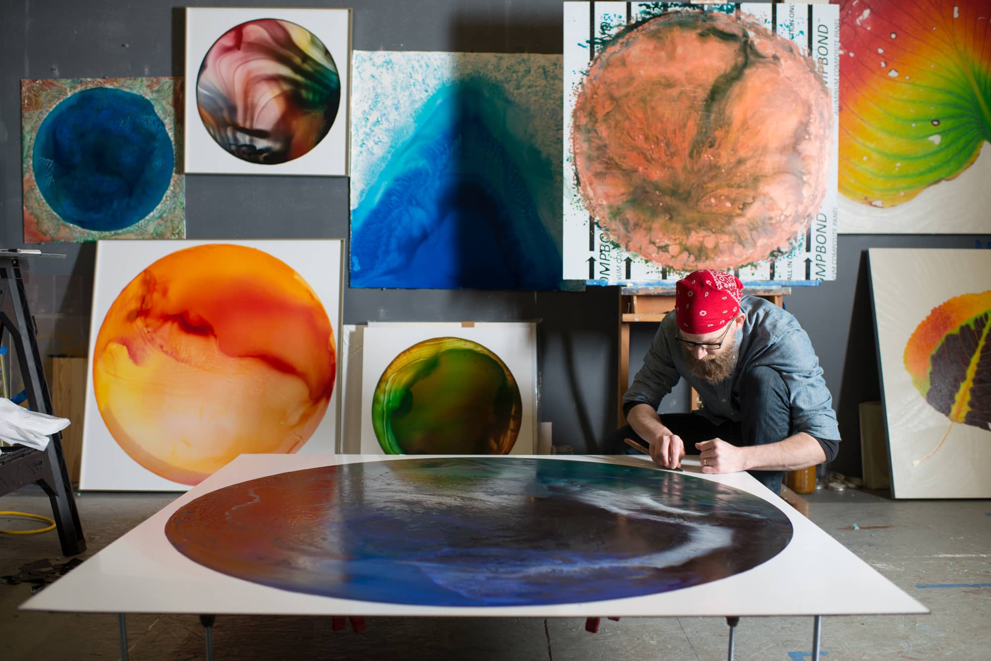 Artist and College of Fine Arts Professor of Painting + Drawing John Sabraw works on a painting at his home studio in Athens, Ohio.