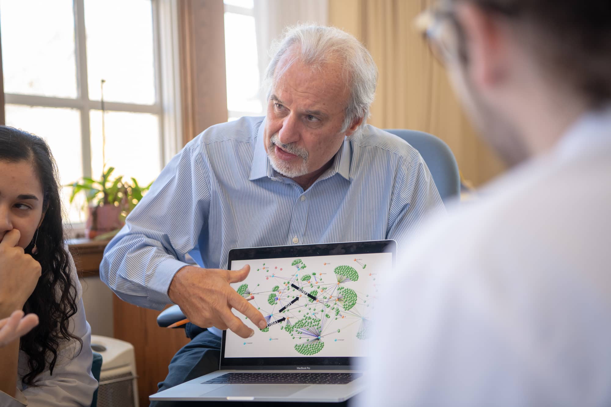 John Kopchick, Ph.D., explaining a diagram on a computer