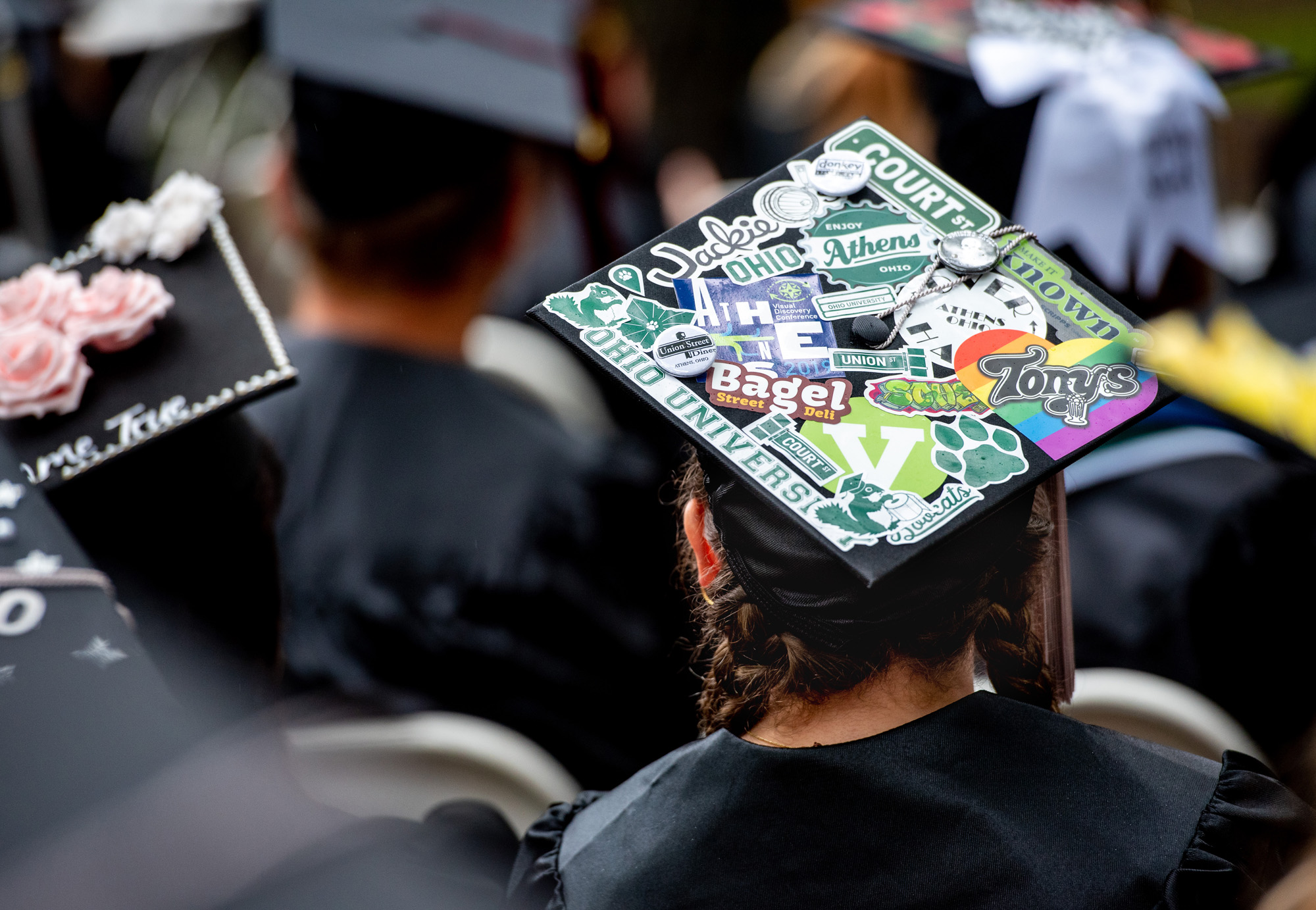 Seniors decorate their graduation caps with various stickers and patches