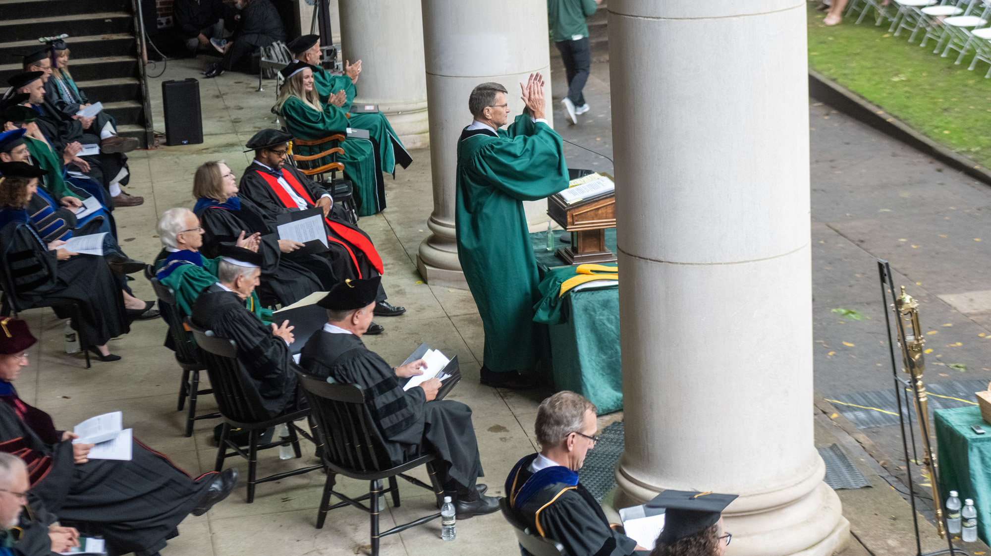 The faculty and administration arranged under the awning behind Memorial Auditorium