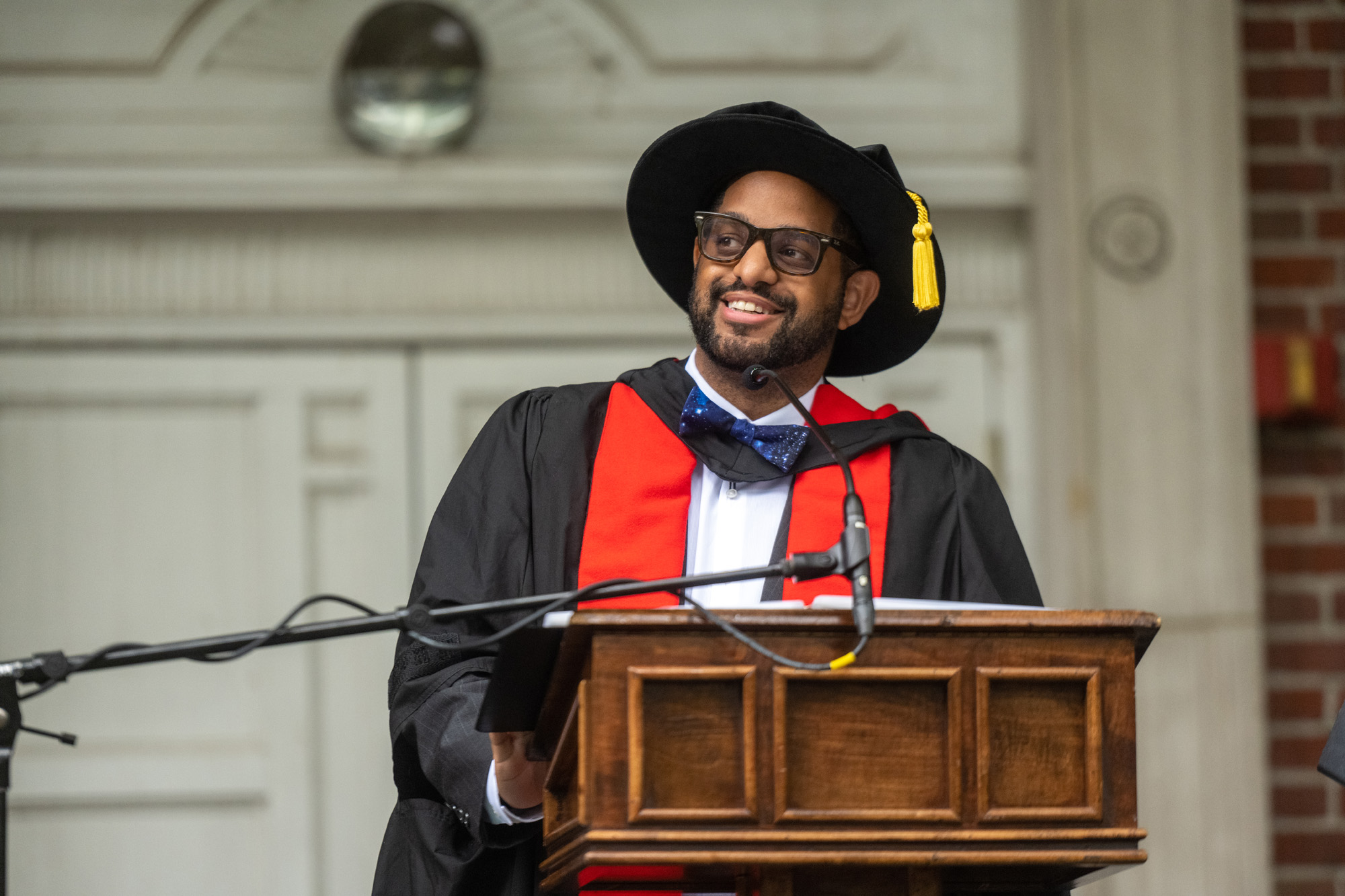 Commencement speaker, Keith Hawkins, stands at a podium to deliver an address