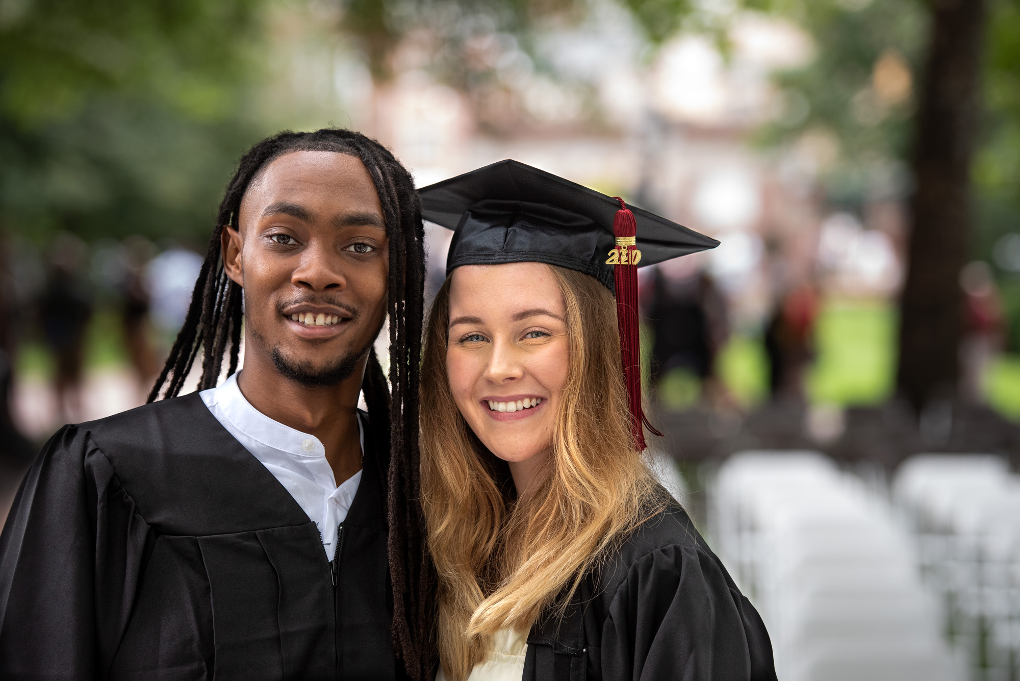 Two students pose for a photo after the graduation ceremony