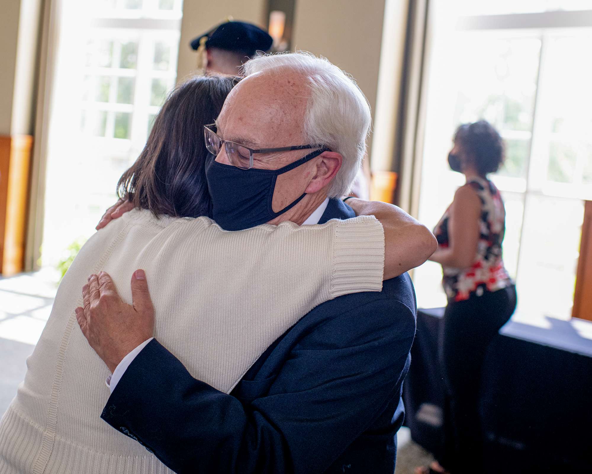 Hugh Sherman hugs Trustee Lorrie Platt