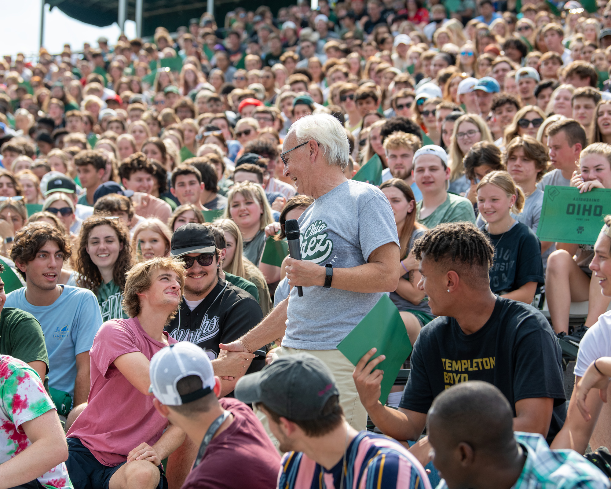 President Sherman shakes the hand of a student while delivering a talk to the incoming class of freshmen students