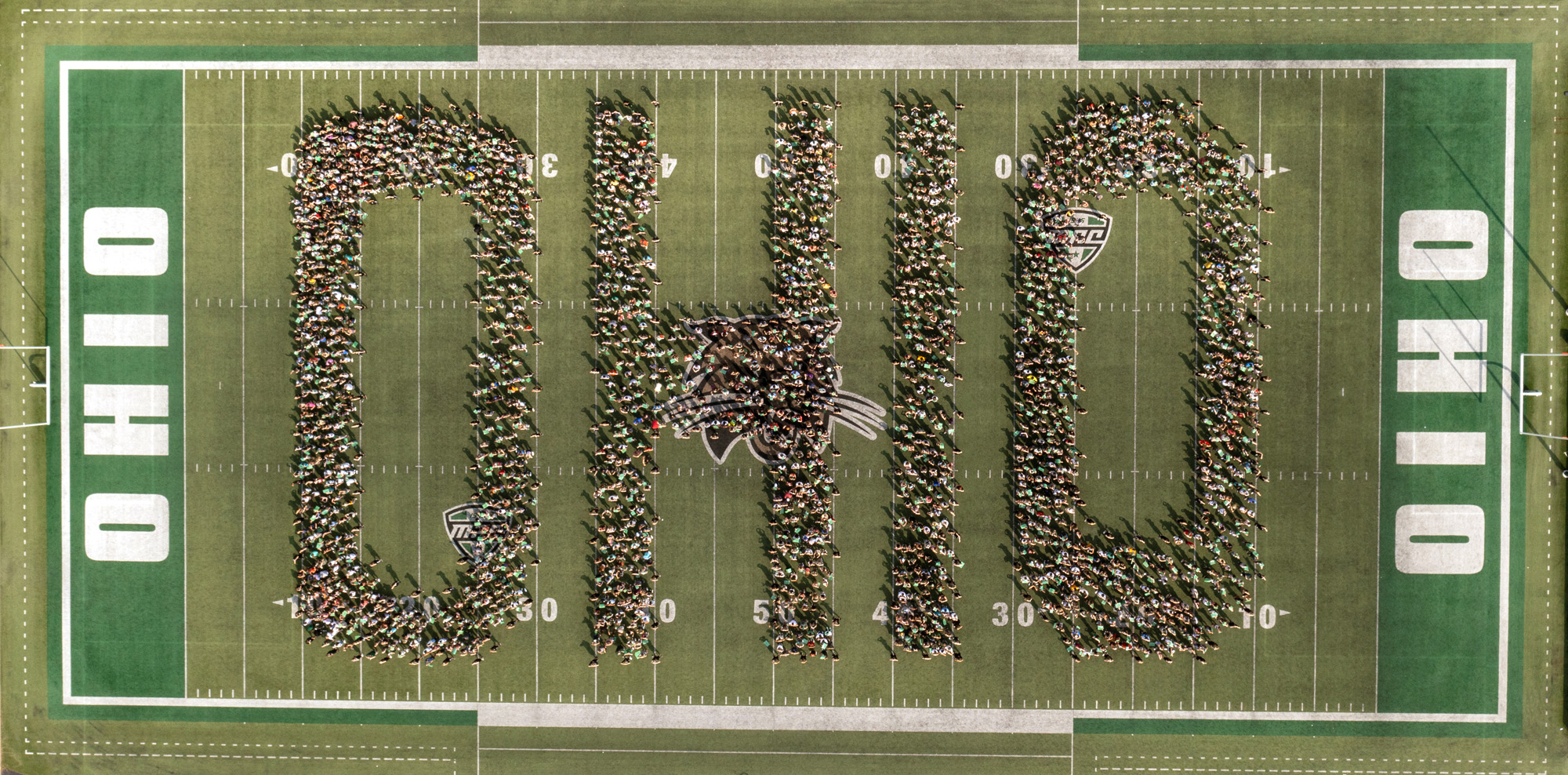 The class of 2025 organized in the shape of OHIO as seen from a drone