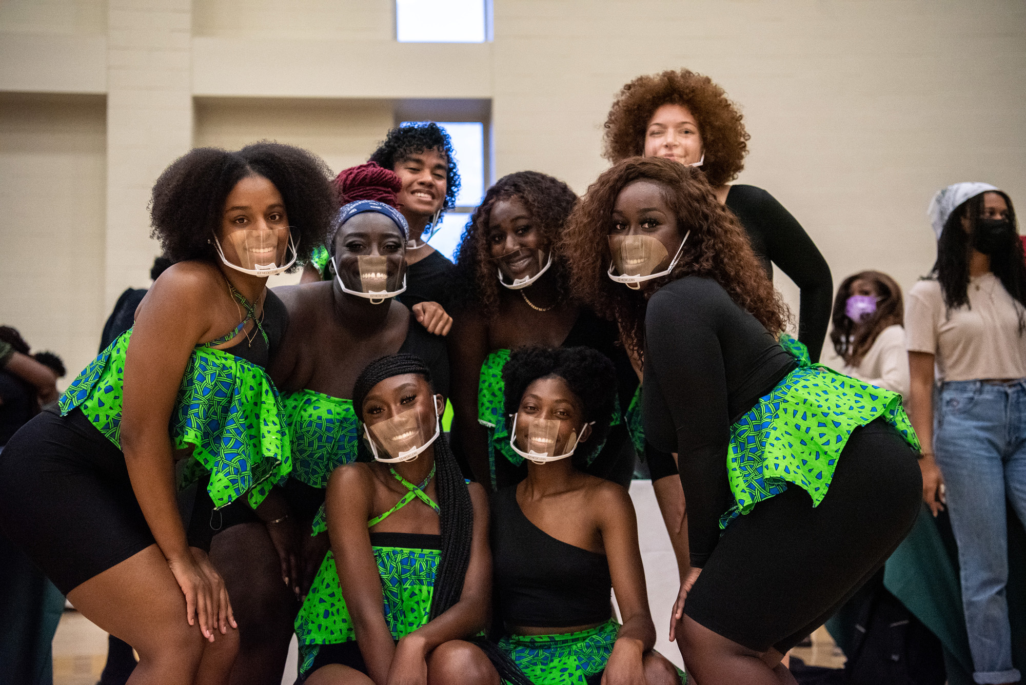 A group of performers pose in matching outfits during the Multicultural Expo