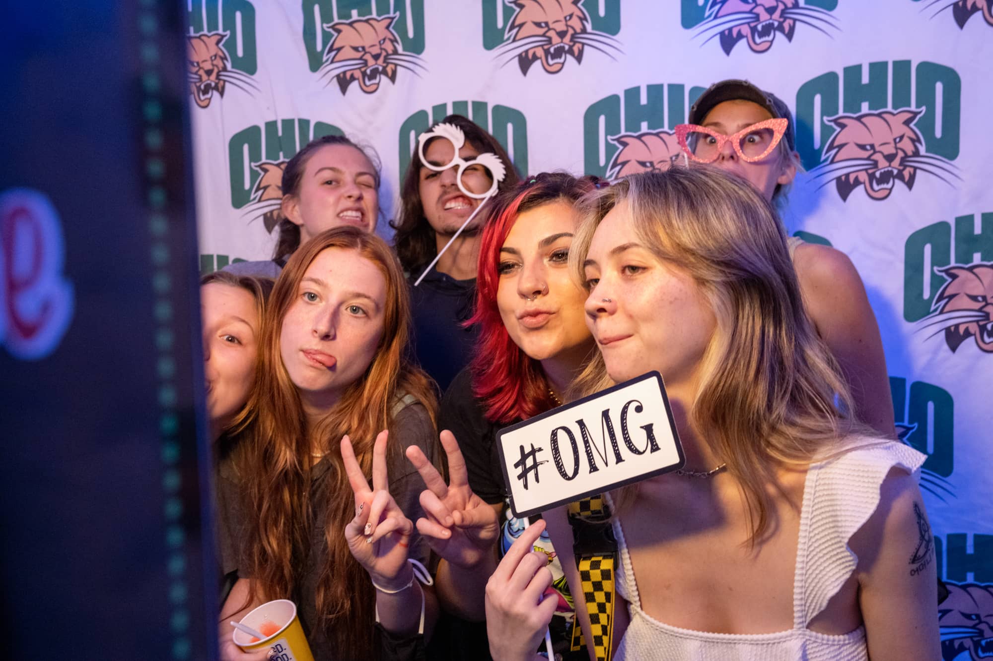 Students pose for a photo together in photo booth at a Yard Games event night on South Green.