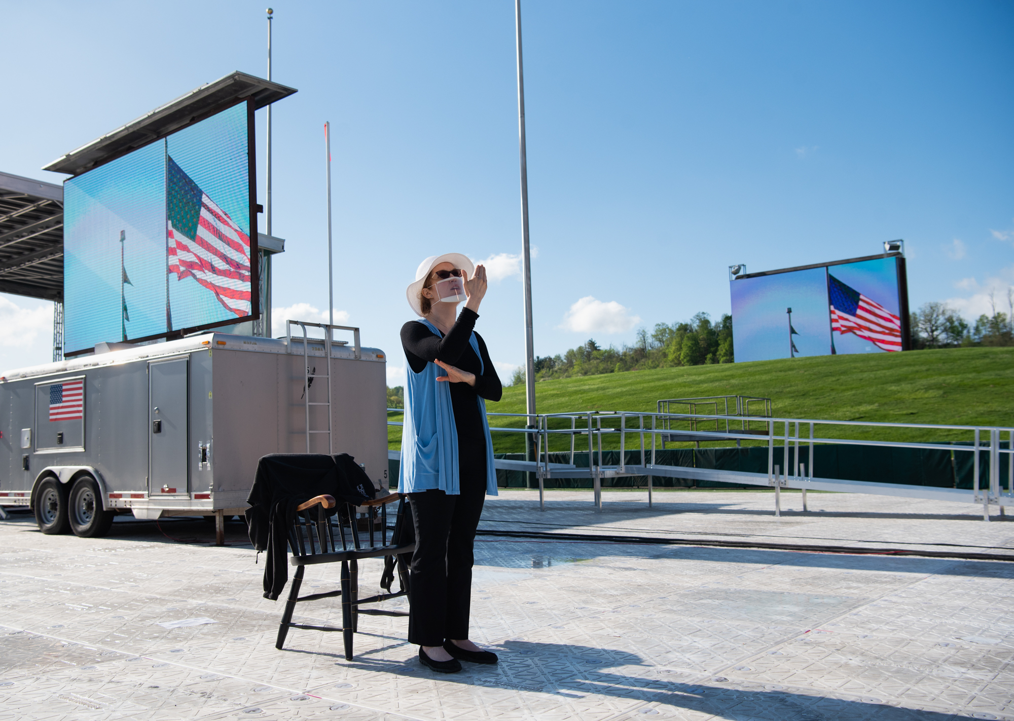 The sign language interpreter standing all alone