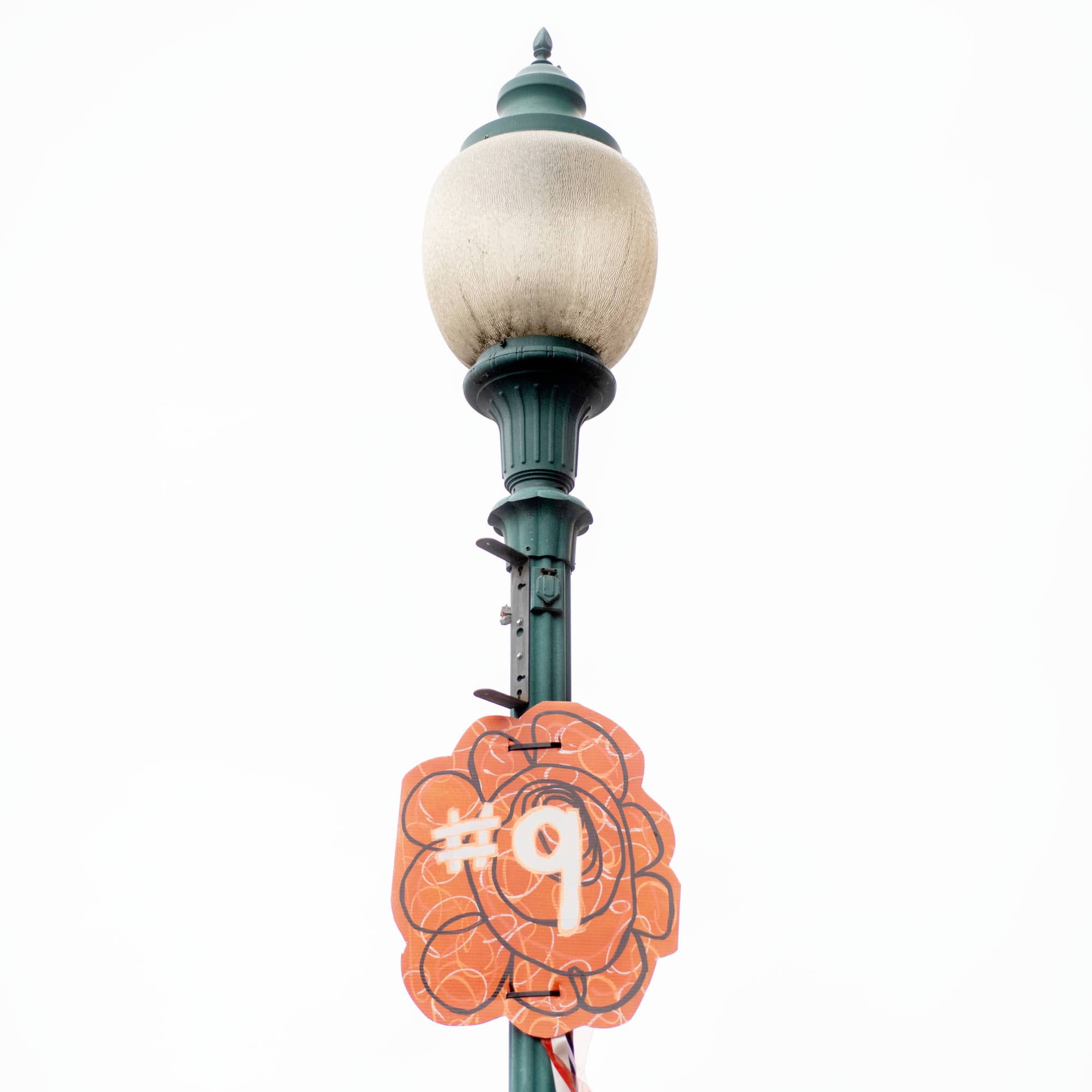 Flowers showcasing Joe Burrow's jersey number are on display along lamp post along Court Street in Athens. The local community arts center Passion Works Studio used repurposed materials to make the decorum.
