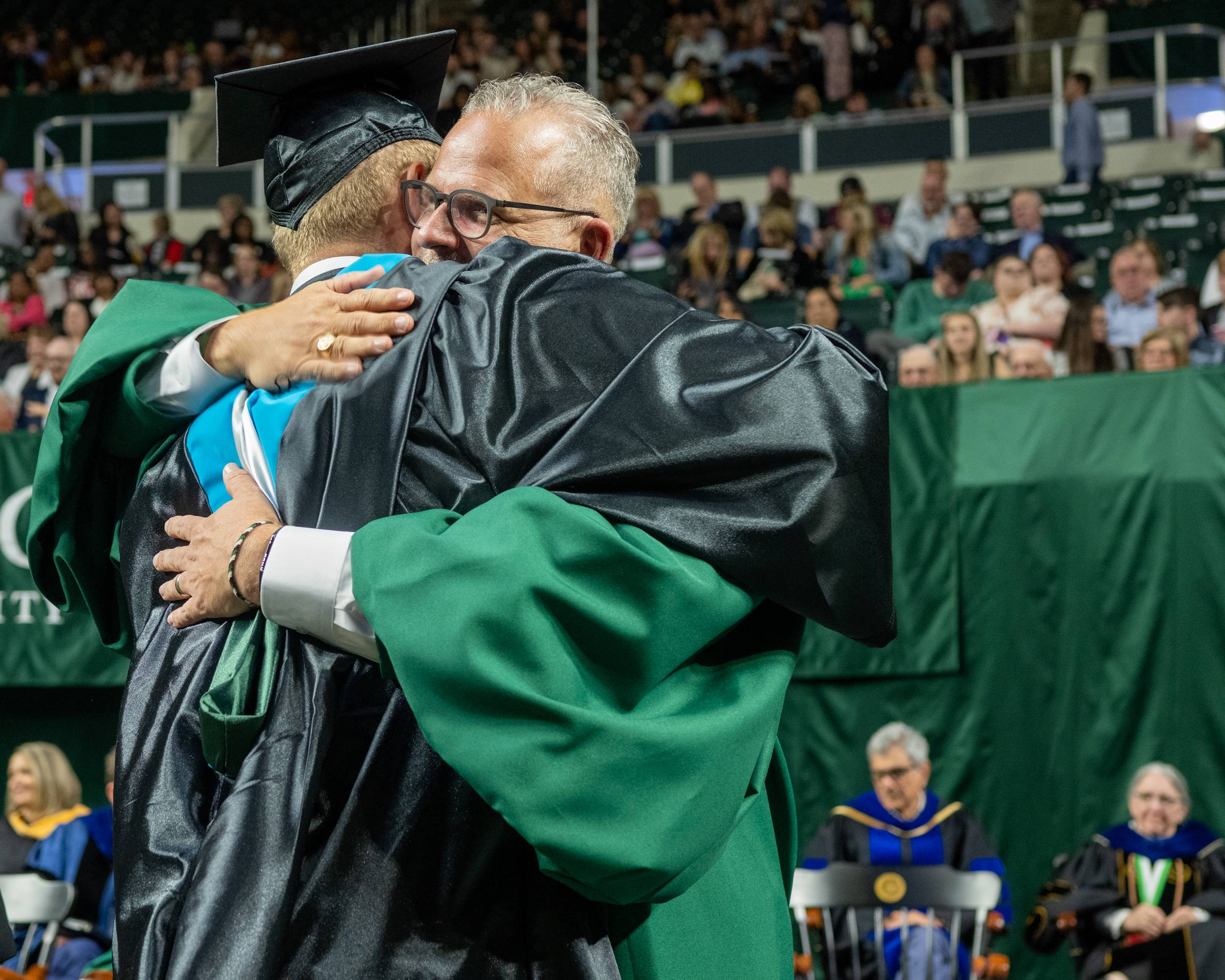 Trustee Matt Evans congratulates a new OHIO graduate.