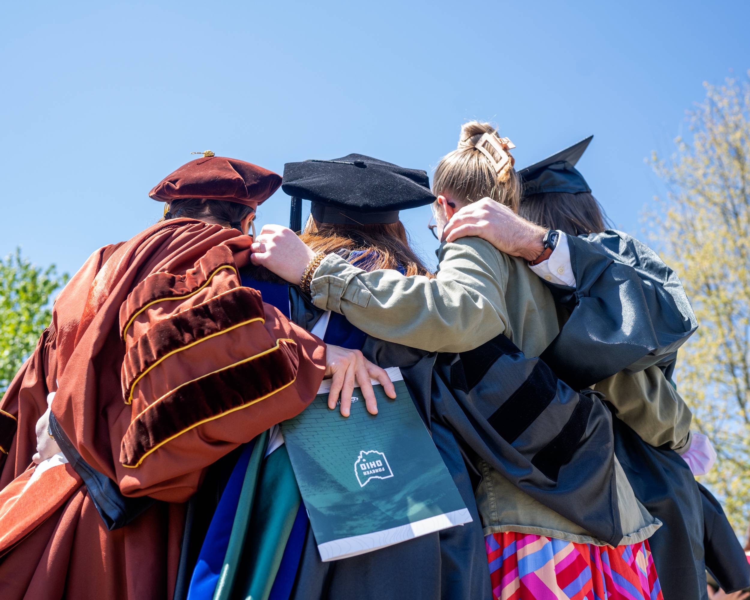 Pausing for a photo outside of the Convocation Center during a beautiful day for Commencement at Ohio University.