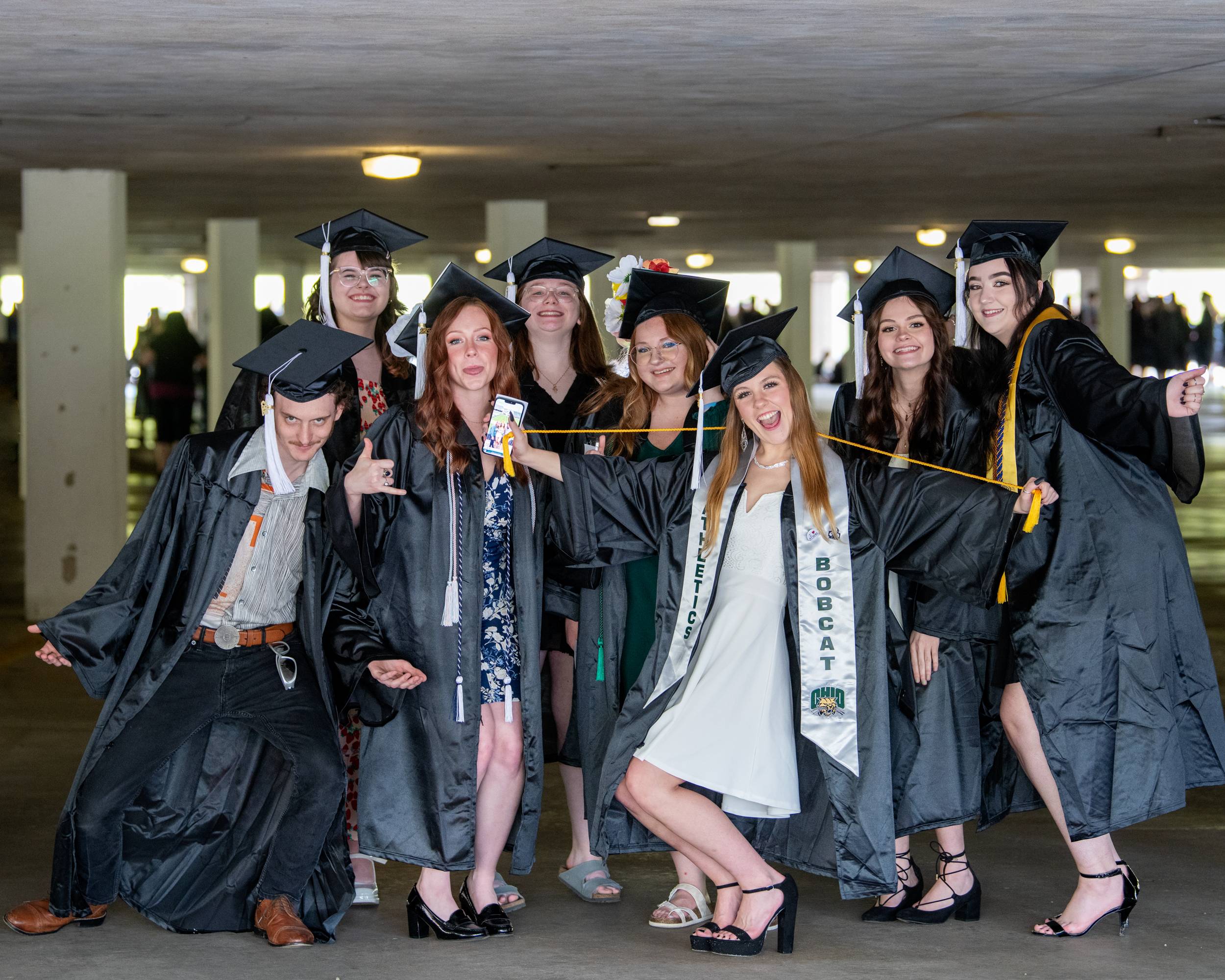 A group of Bobcats pose outside of the Convocation Center, relishing this moment together.