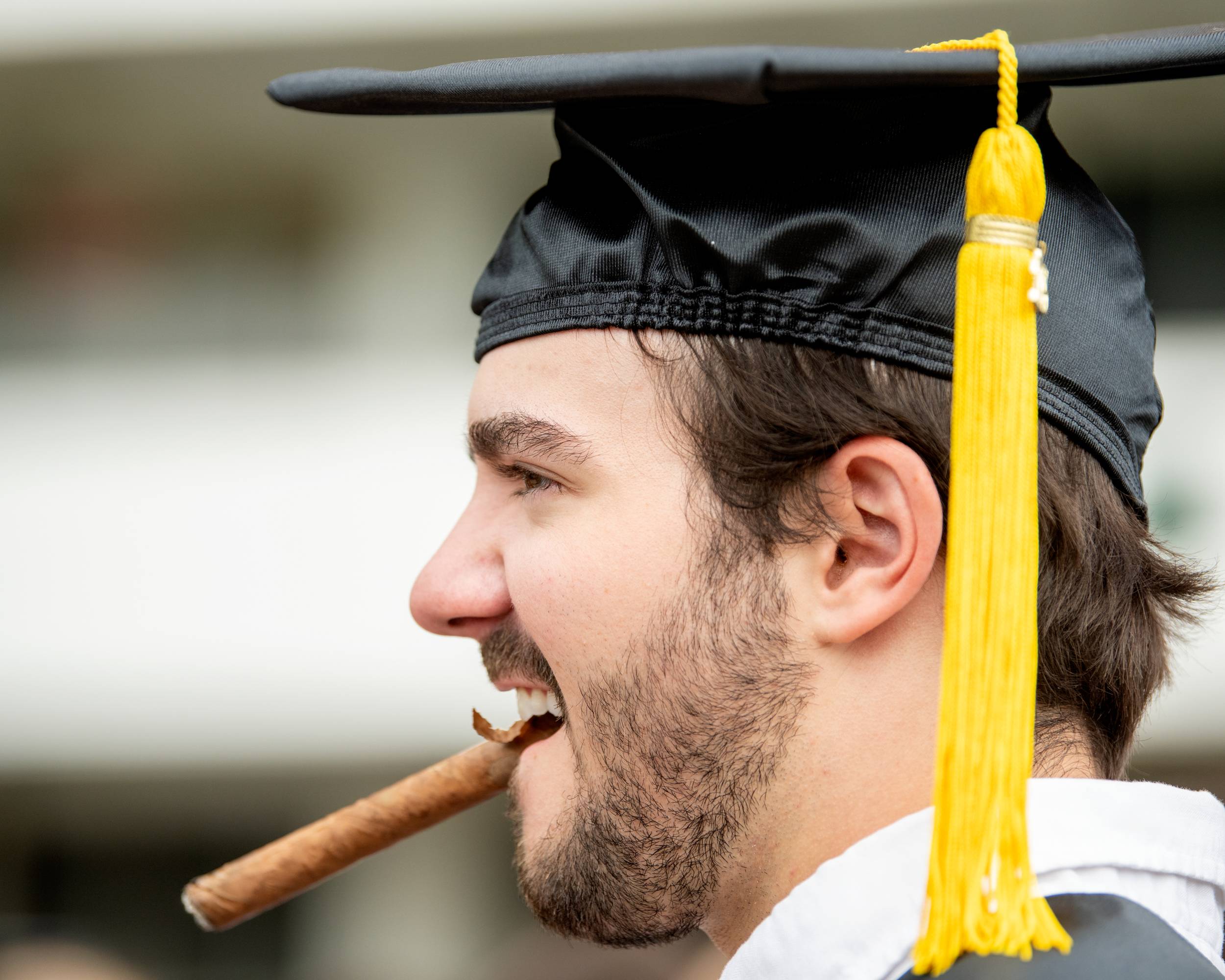 A student celebrates the momentous occasion with a cigar. 