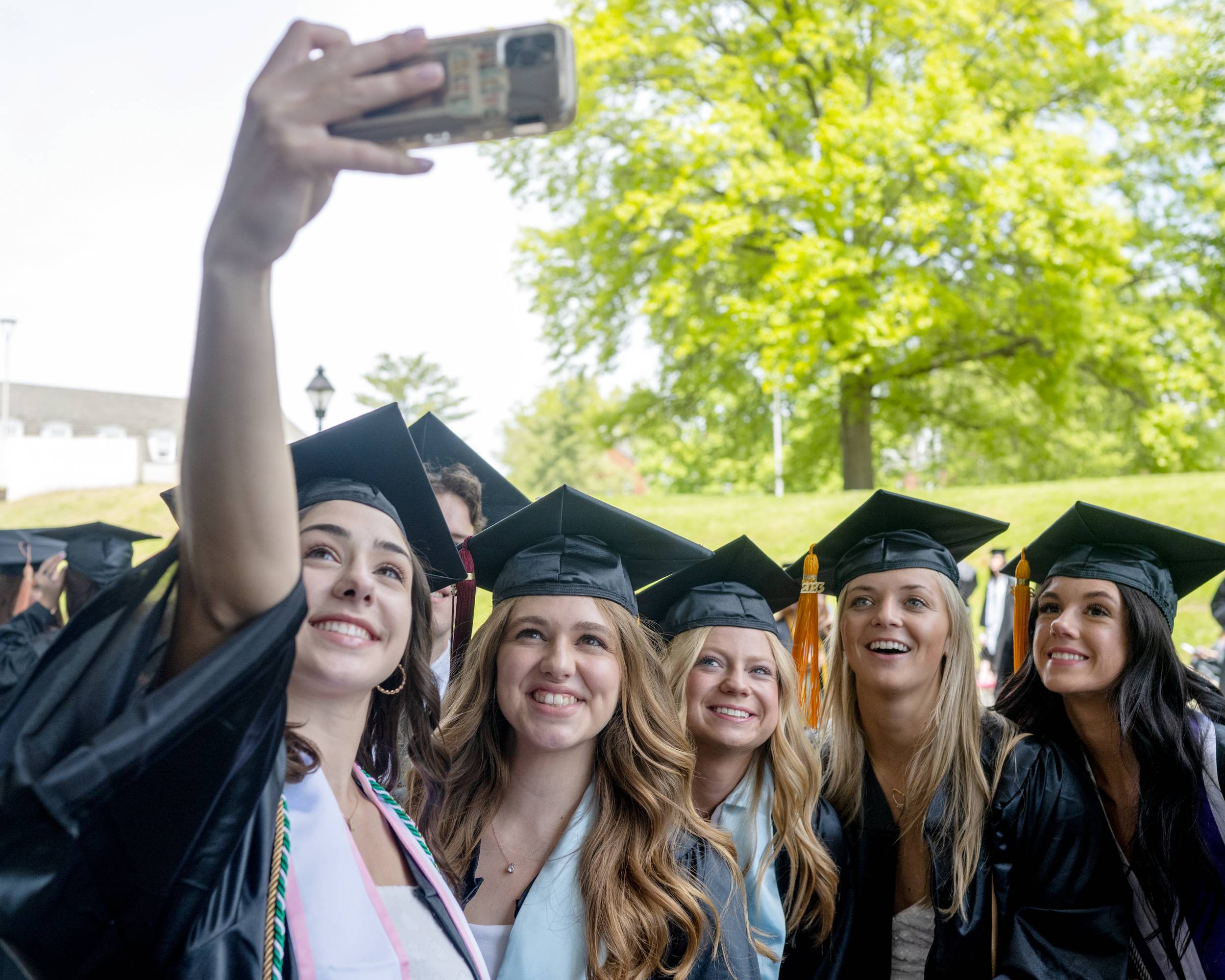 OHIO graduates take a selfie outside of the Convocation Center, capturing the big day they've worked toward together. 