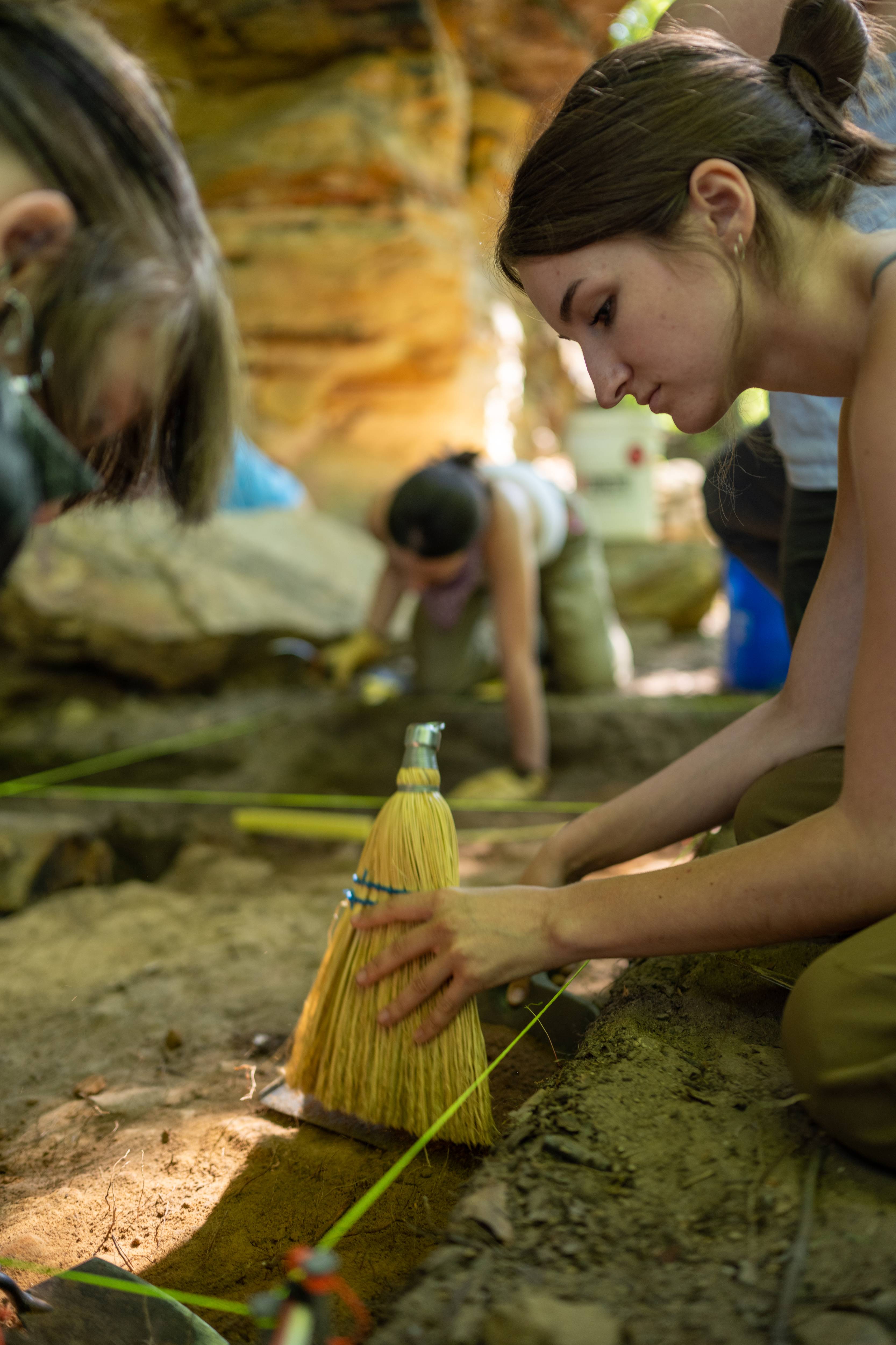 Painstaking work: Students prepared to be uncomfortable for the first half of Field School but found the rock shelter provided much-needed shade. Photo by Ben Siegel