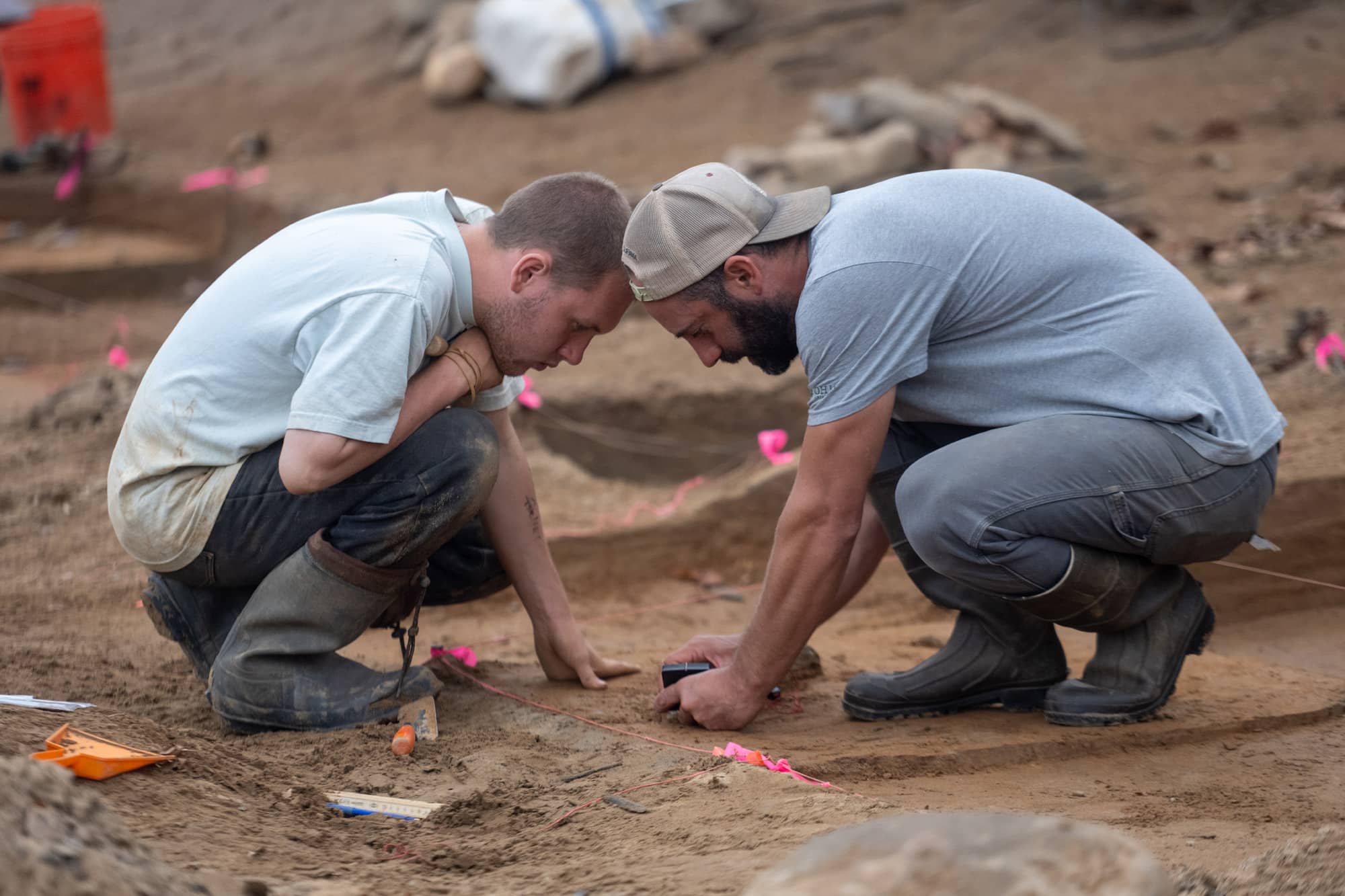 Dr. Joseph Gingerich teaches student Hunter Arnett how to map artifacts.