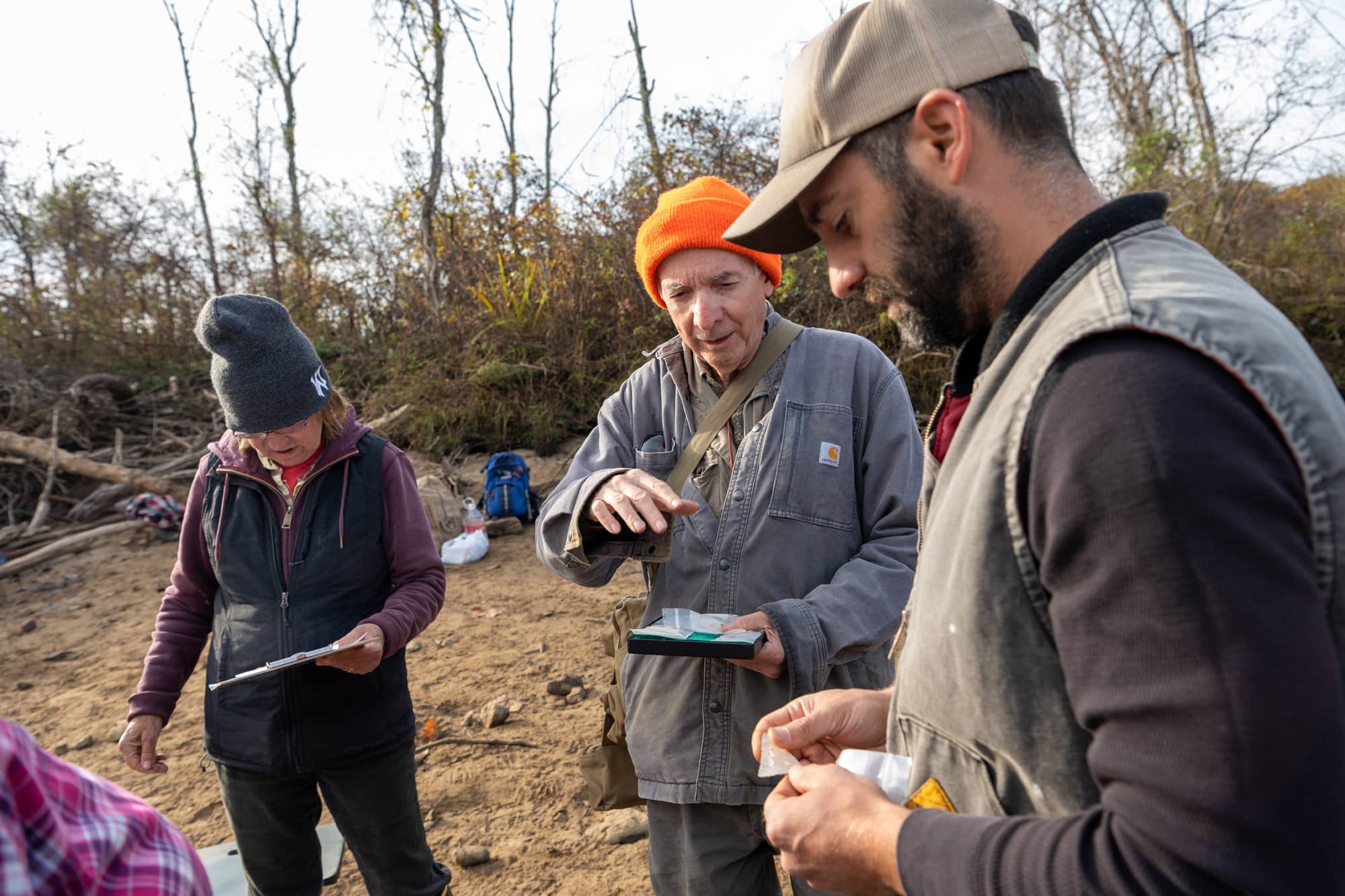 Dr. Gingerich examine artifacts with ASV members Bill Childress and Jeanette Cole. Childress and Cole have extensively work to map and report sites throughout this portion of the Roanoke River valley.