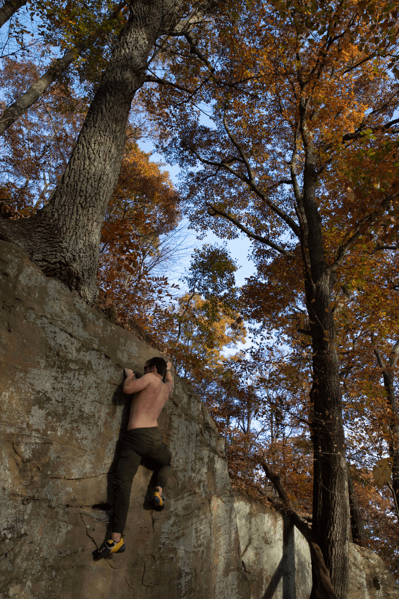 A student boulders at Sells Park in Athens. 