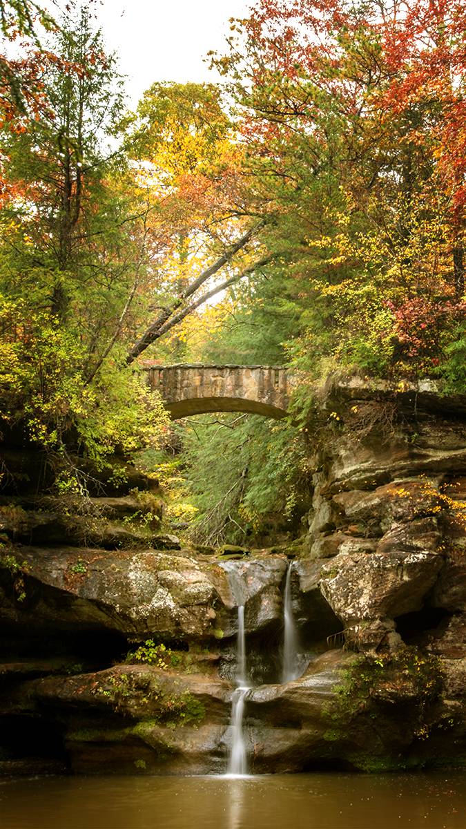 Fall colors frame the Upper Fall at Old Man’s Cave in the Hocking Hills