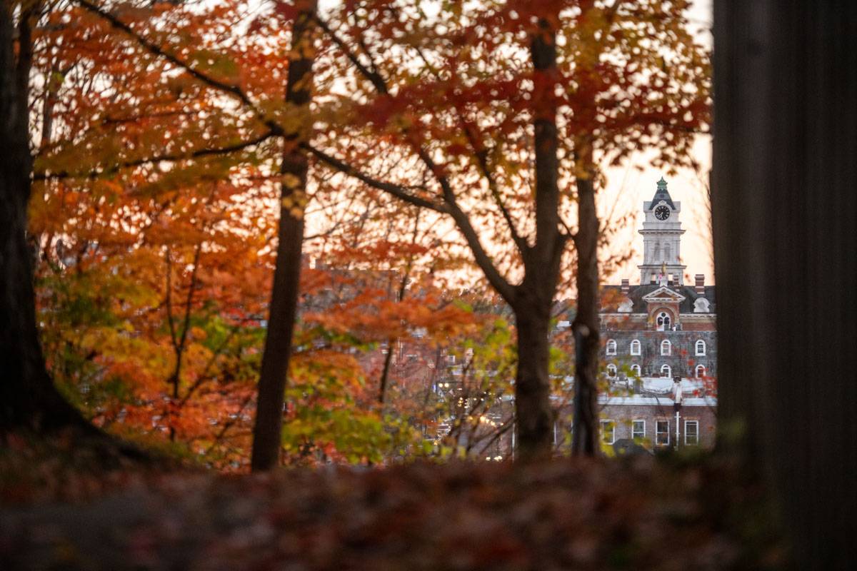 The clocktower on Athens County Courthouse framed by fall colors