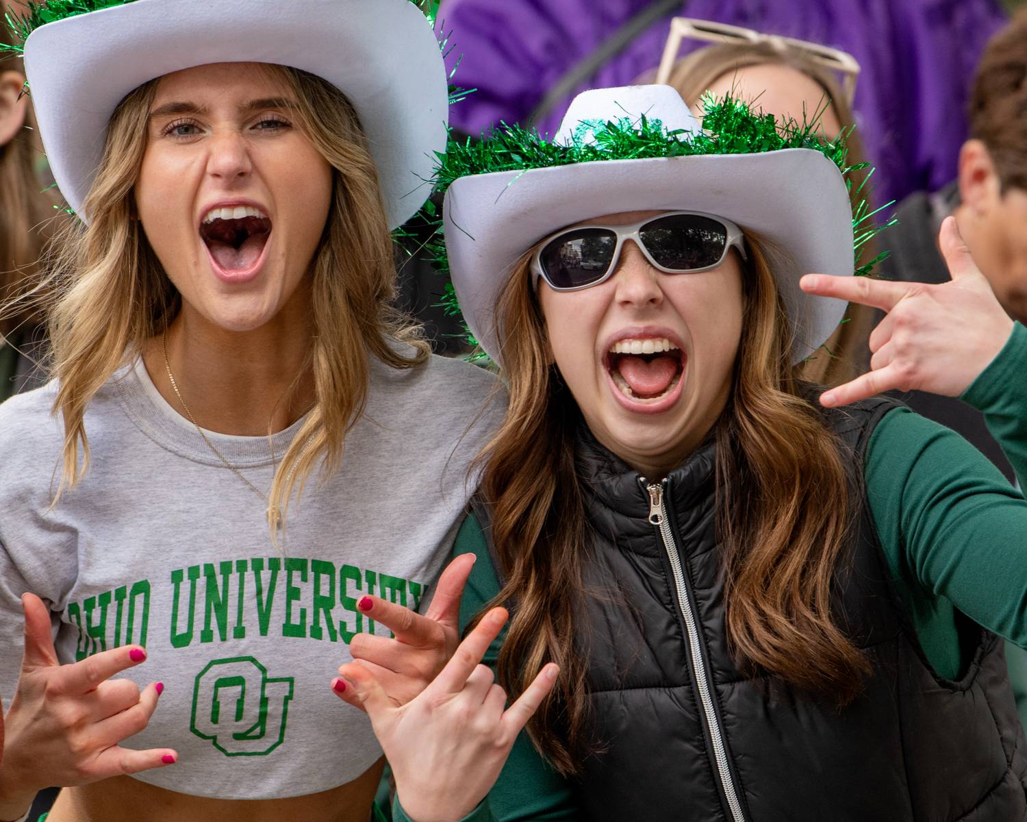 Students cheer for the Marching 110 Alumni Band.