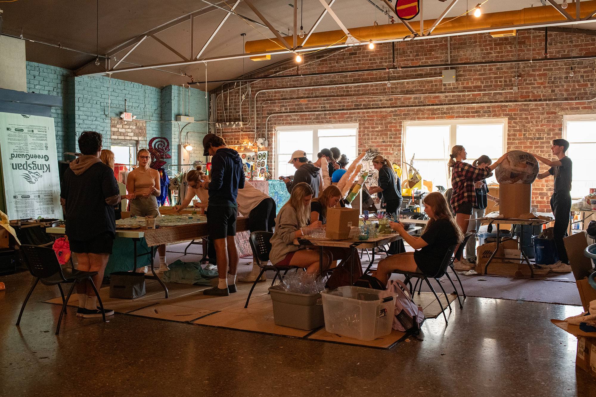 An Ohio University learning community works together to create paper mache pieces for a costume to be worn in the Honey for the Heart parade in Athens, Ohio.