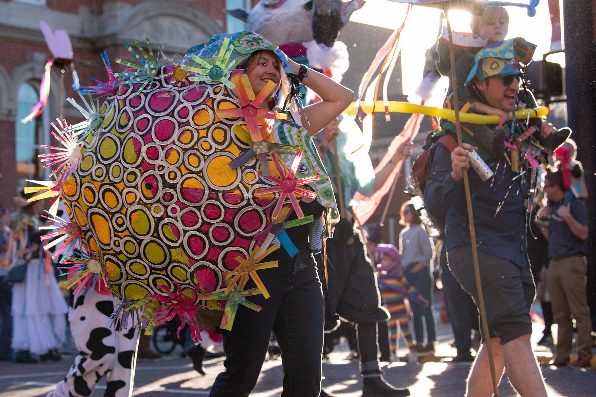 Participants in the 2022 Honey for the Heart parade make their way down Court Street in Athens, Ohio.