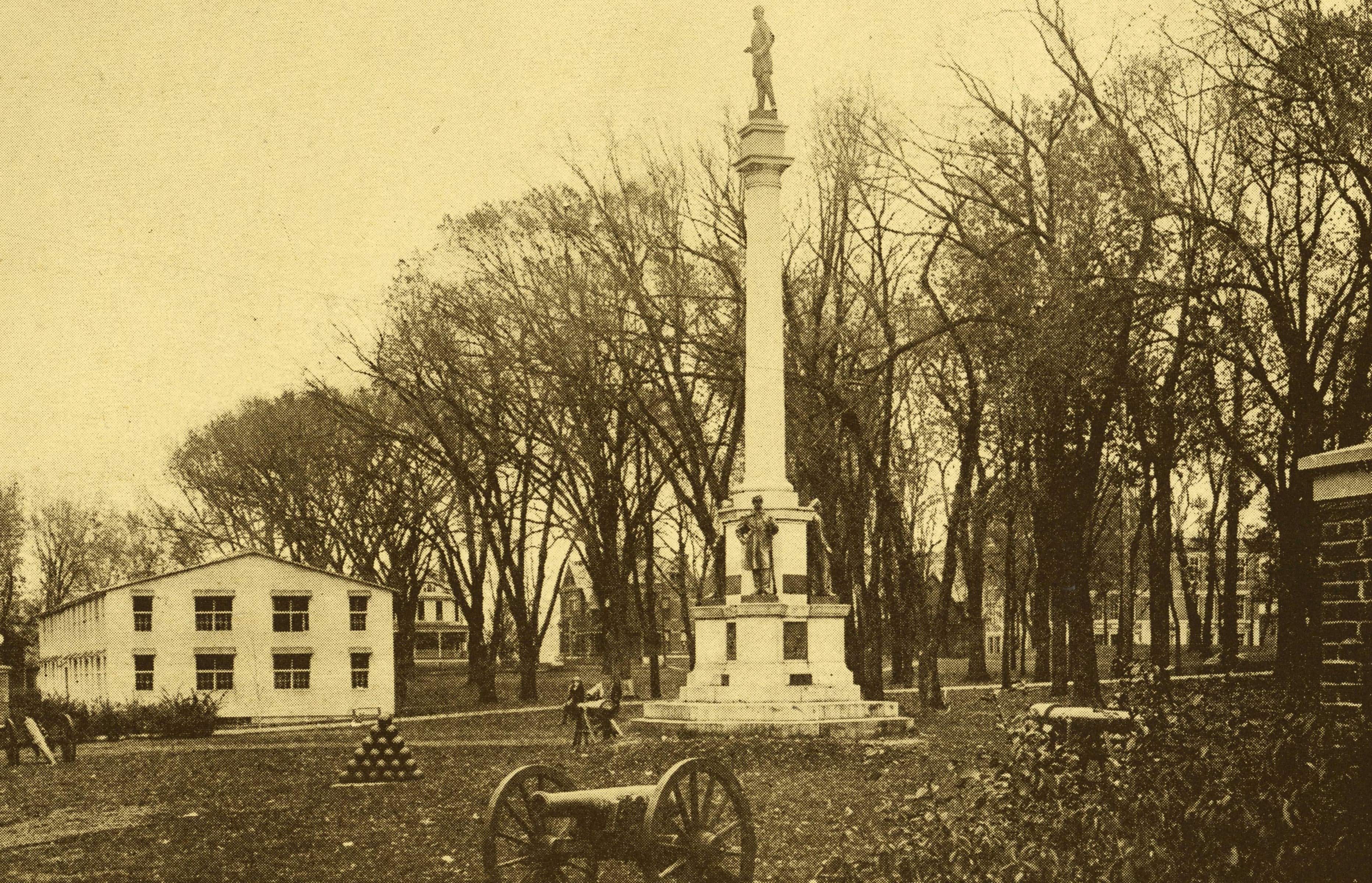 Wooden barracks were installed behind the monument in the late 19-teens. Student trainees in the Student Army Training Corps and Student Navy Training Corps were housed in the barracks and in nearby Howard Hall. Photo courtesy the Mahn Center for Archives & Special Collections
