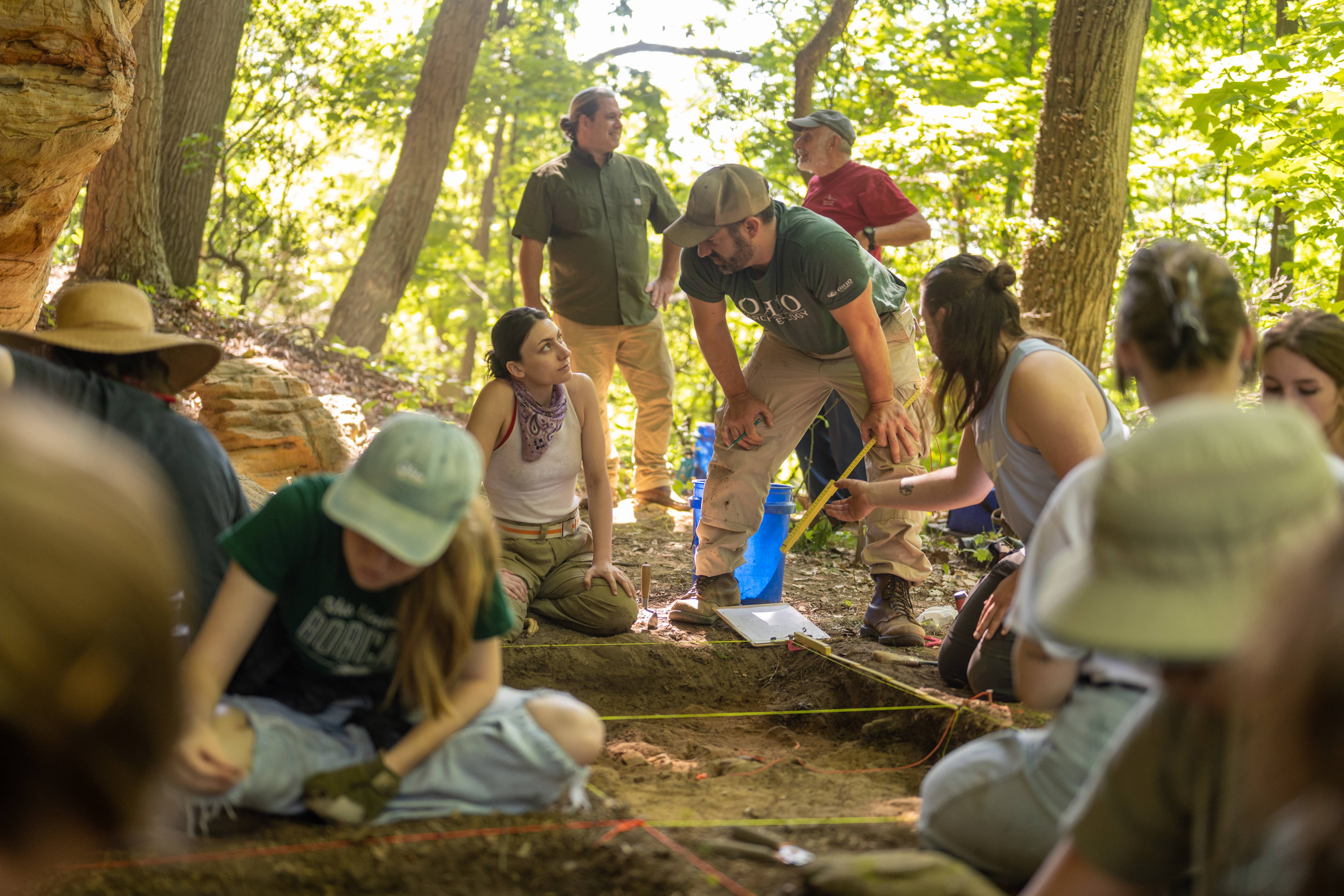 Gingerich (green shirt) talks excavation strategy with field school student Emily Brock (white tank).