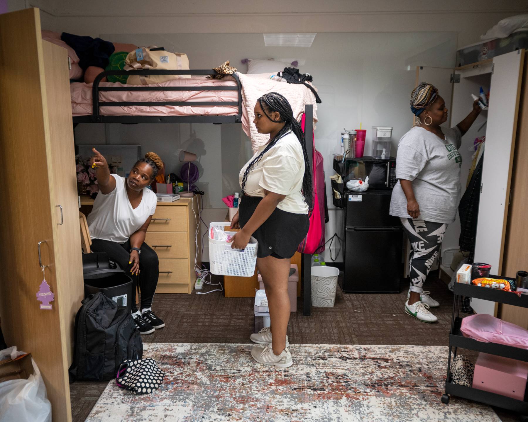 A student gets help from family as they move into their new residence hall room