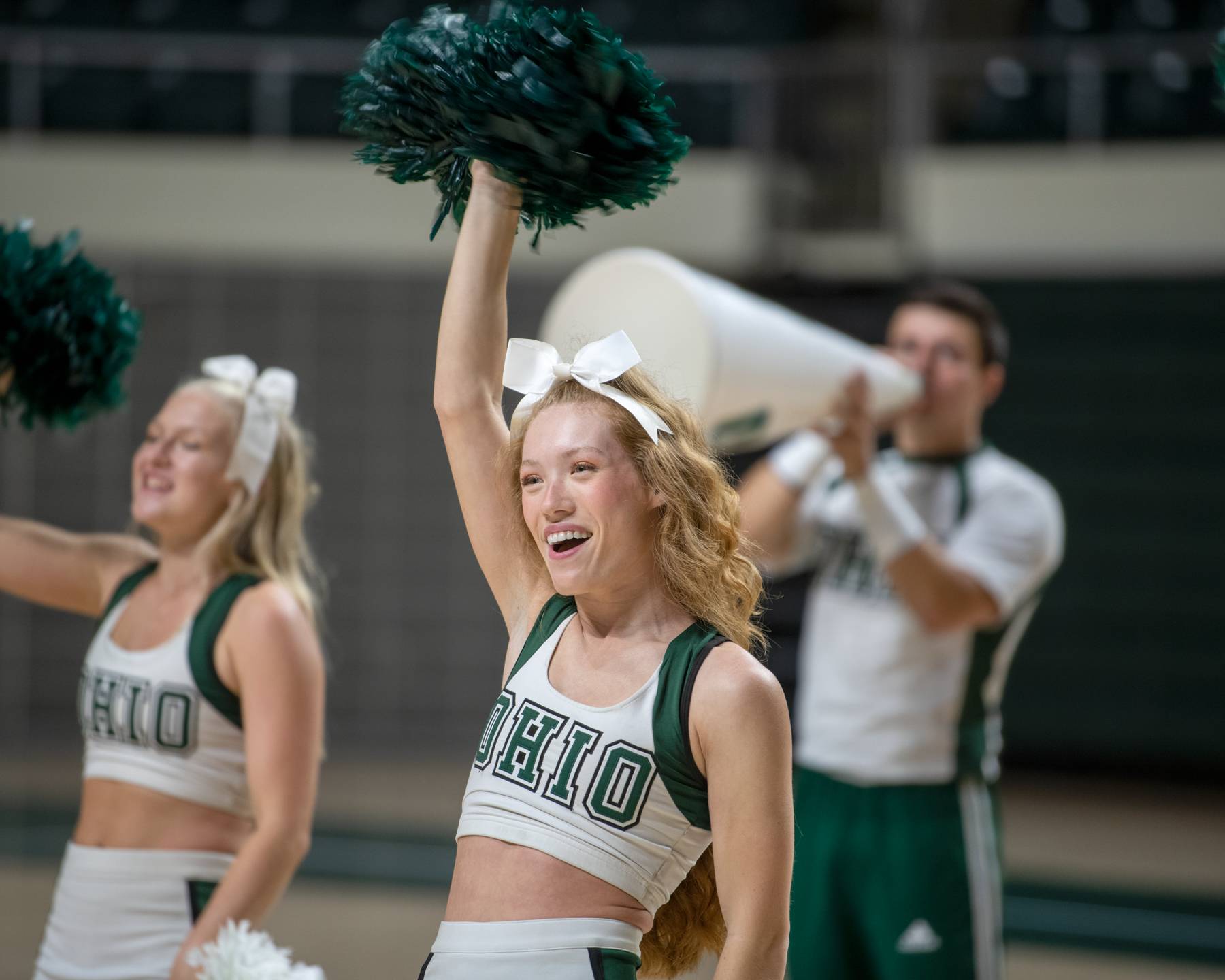 A cheerleader performs at the First-Year Student Convocation