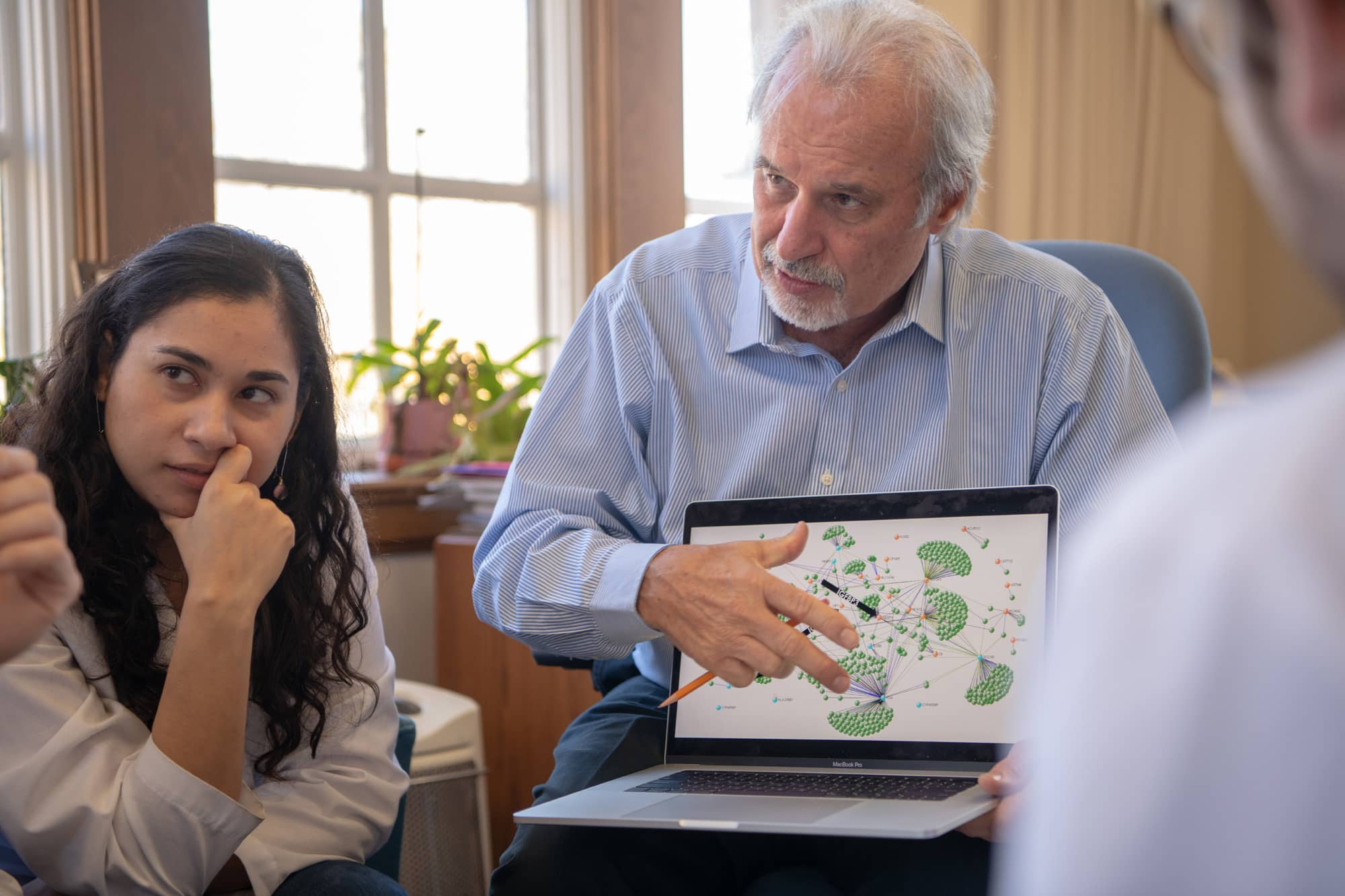 Dr. John Kopchick reviews data with his team at the Edison Biotechnology Institute.