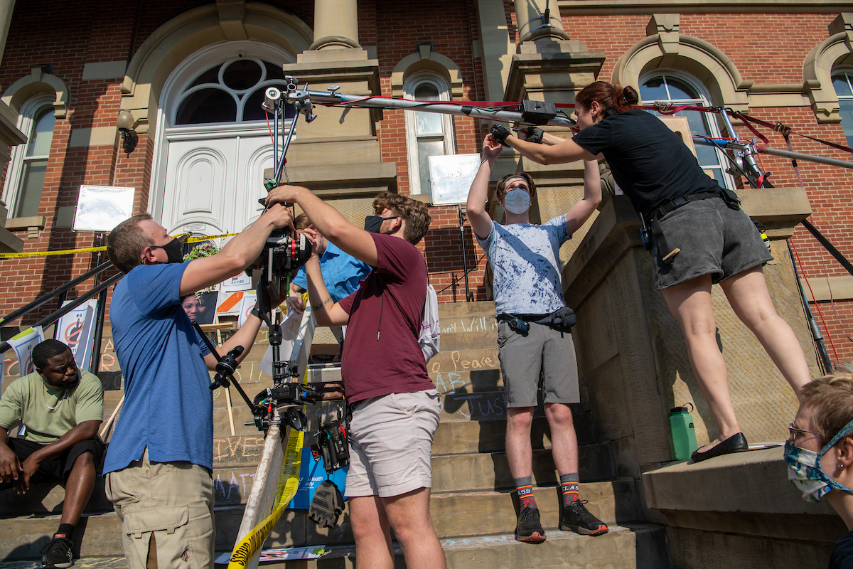 The crew sets up a camera rig in front of the Athens County Courthouse