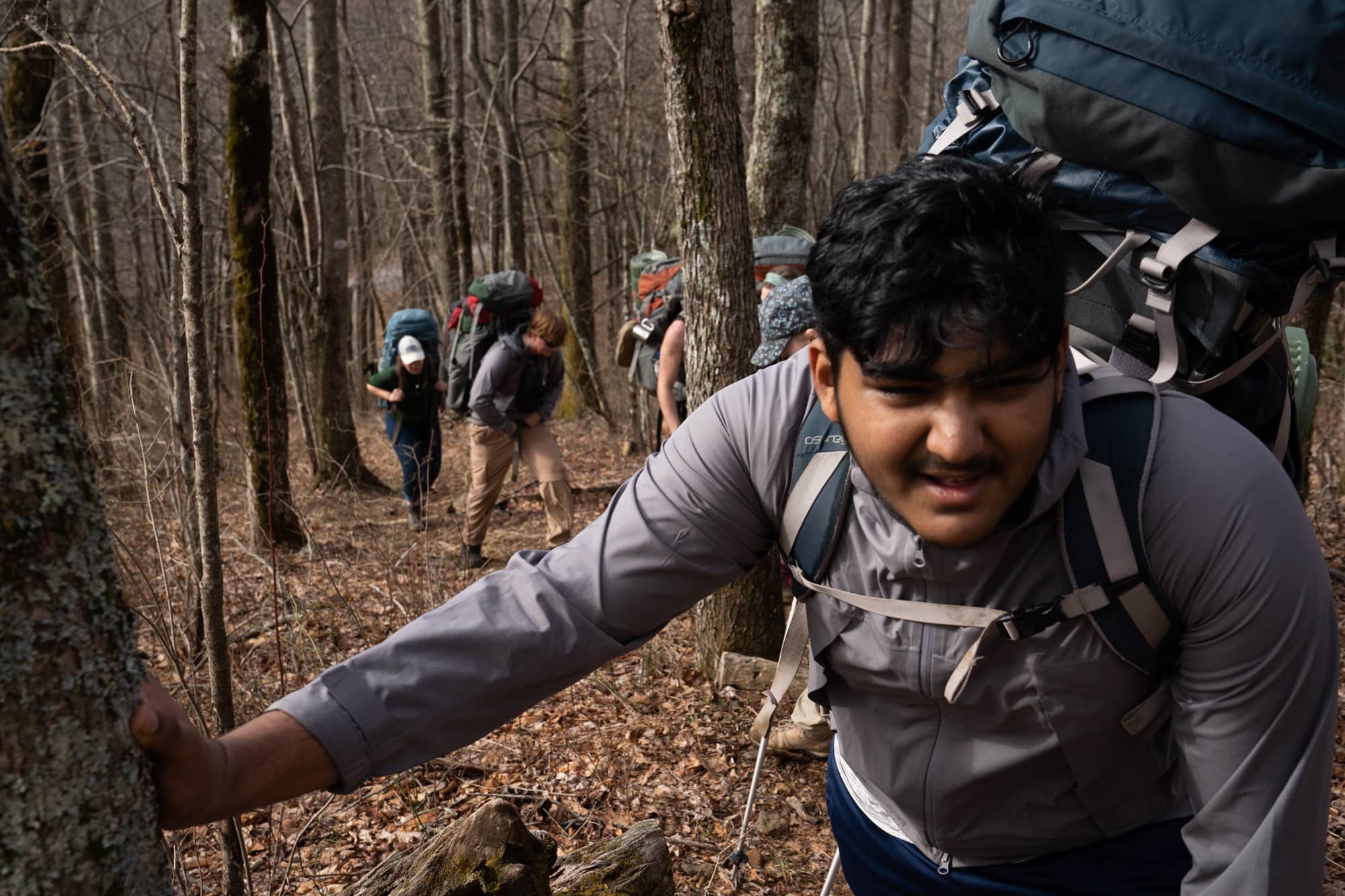 Vishnu Palanki rests his hand on a tree during his fourth day backpacking a section of the Appalachian Trail in the Nantahala National Forest on Tuesday, March 8, 2022, near Franklin, North Carolina.