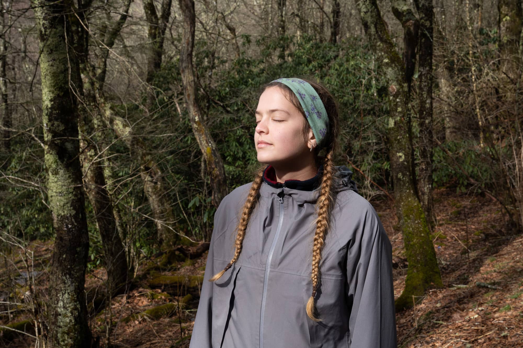 Regan Magee takes a moment to herself in the sunlight during her fifth day backpacking a section of the Appalachian Trail in the Nantahala National Forest on Wednesday, March 9, 2022, at the Cold Springs Shelter near Franklin, North Carolina.