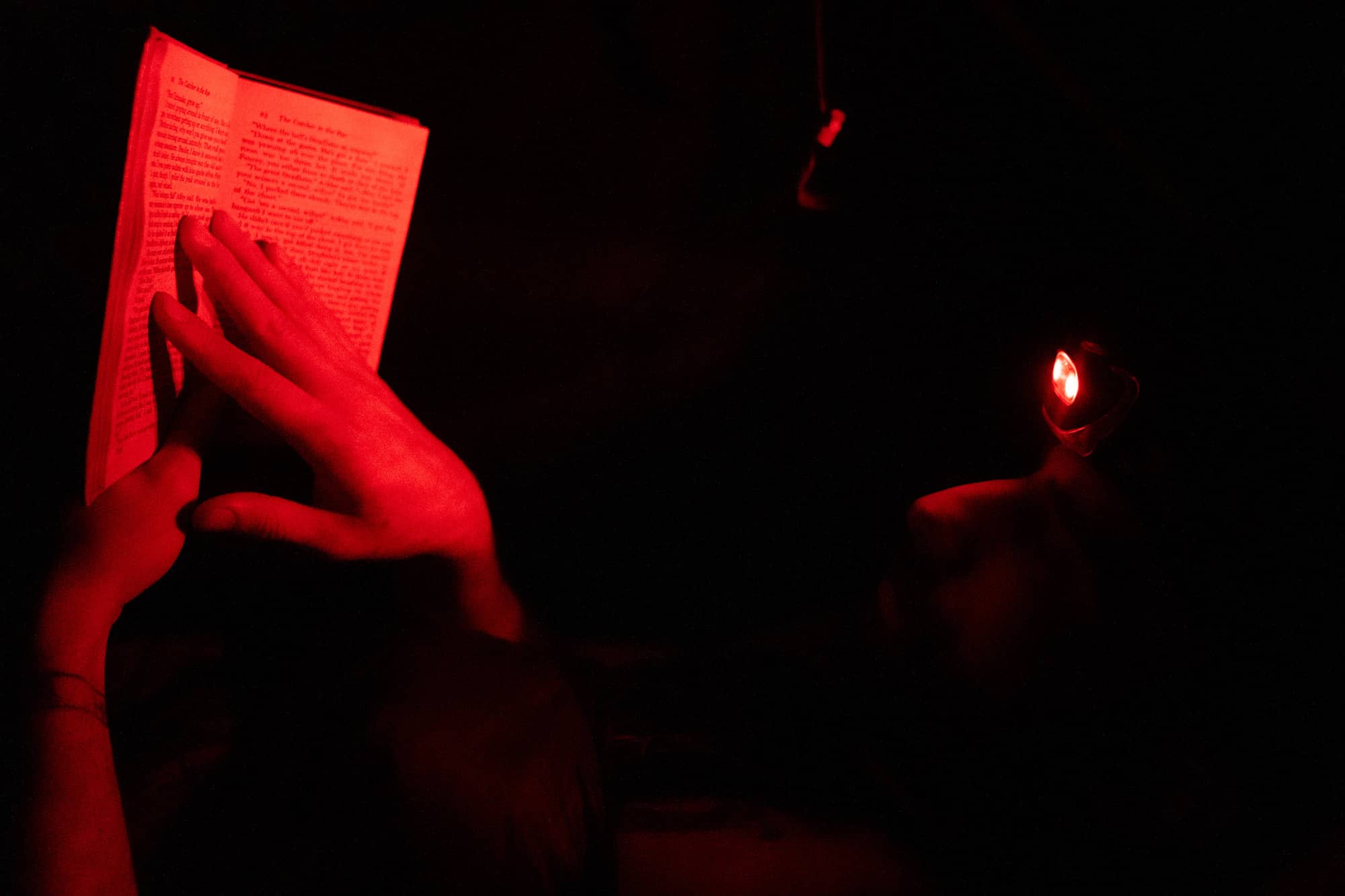 Eamonn Bell reads "The Catcher in the Rye," while resting in his tent at the Rock Gap campground during his second day backpacking a section of the Appalachian Trail in the Nantahala National Forest on Sunday, March 6, 2022, at the Moore Creek Camp near Franklin, North Carolina.