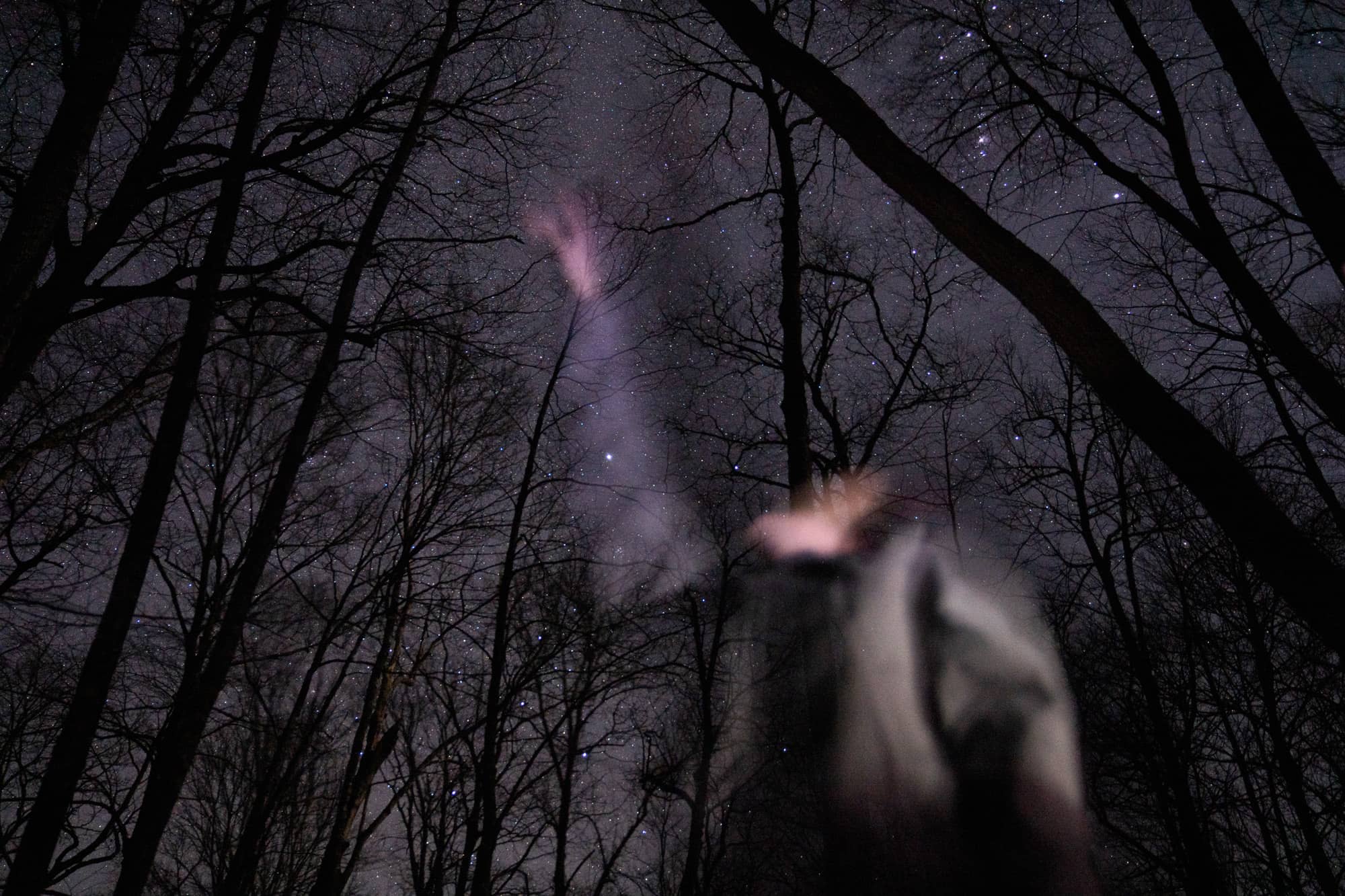 Katelyn Rousch points towards a constellation during her second day backpacking a section of the Appalachian Trail in the Nantahala National Forest on Sunday, March 6, 2022, at the Moore Creek Camp near Franklin, North Carolina.