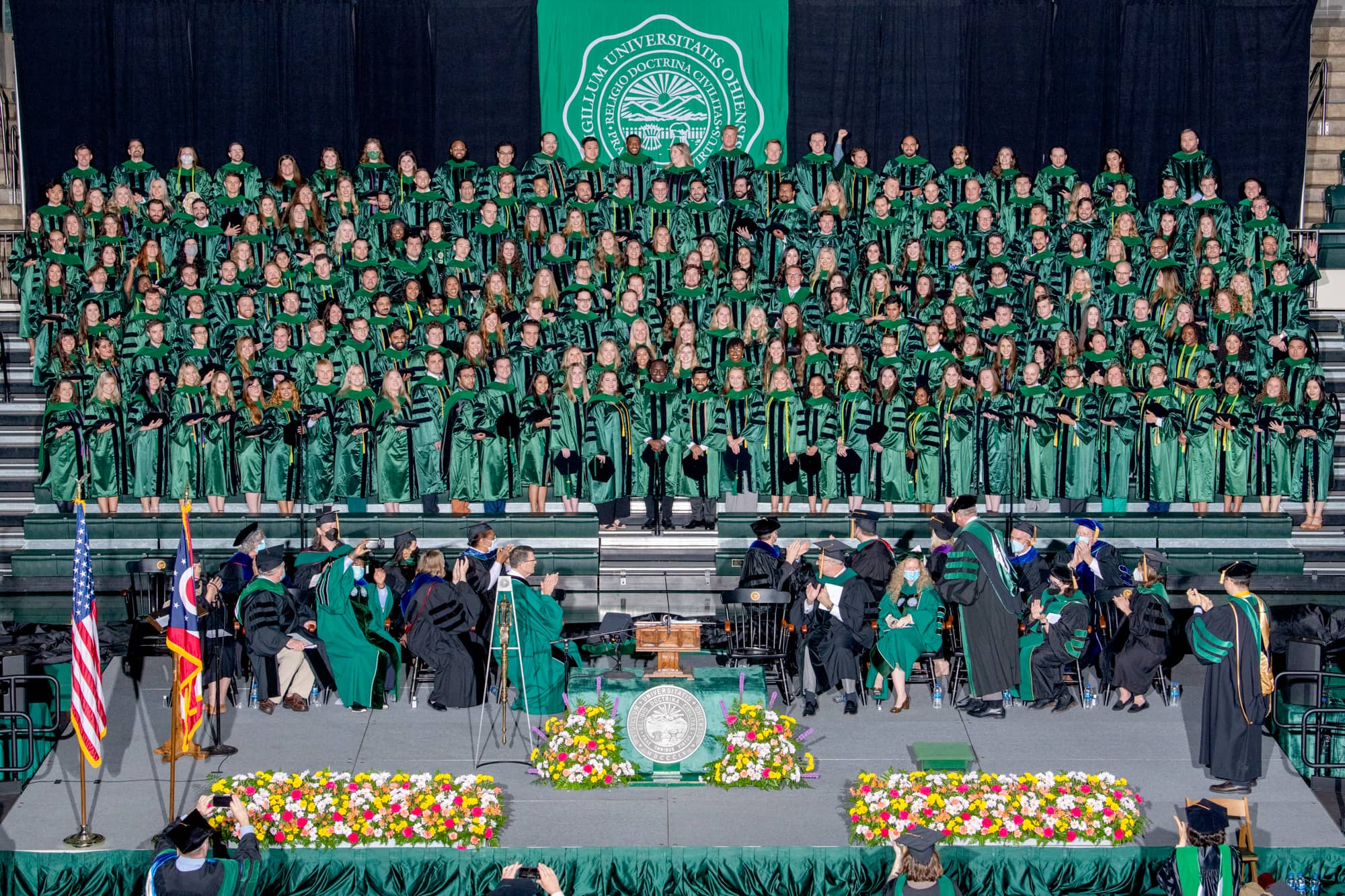 The Heritage College Class of 2022 poses for a photo on stage at commencement.
