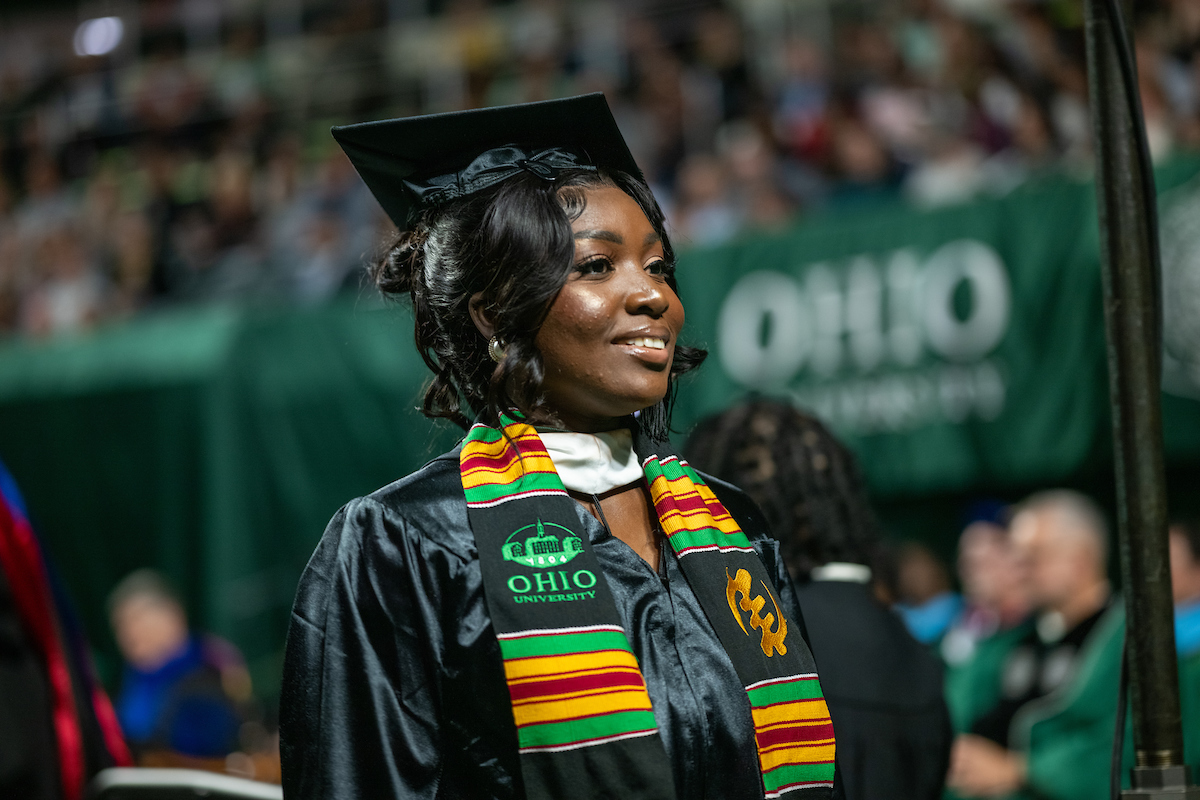 Woman in regalia at Fall 2023 commencement ceremony