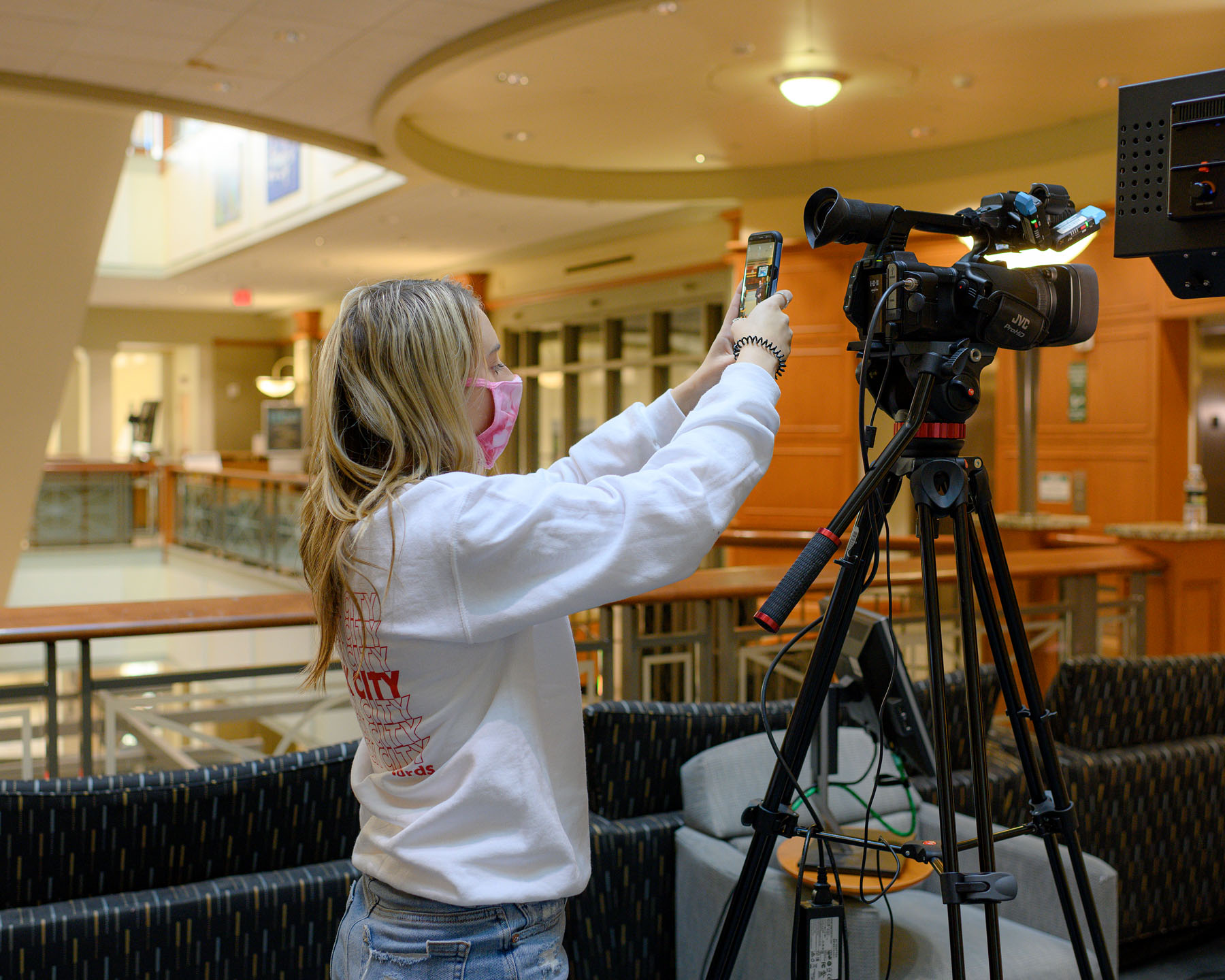 A student sets up a video camera in Baker University Center