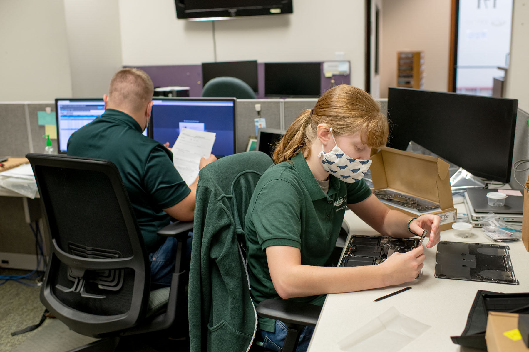 People in OIT working on computer repairs