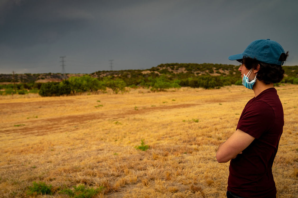OHIO student James Zinnbauer watches the storm in the distance.