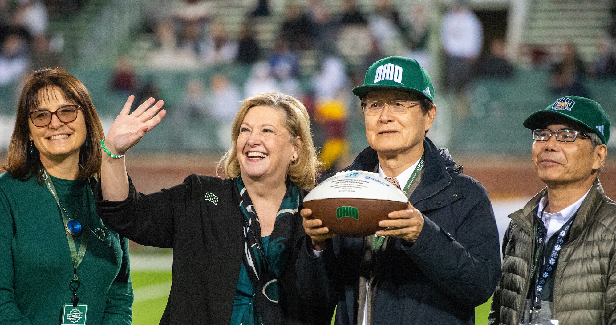 OHIO and Chubu officials are shown while being recognized on the field during the football game in Peden Stadium.