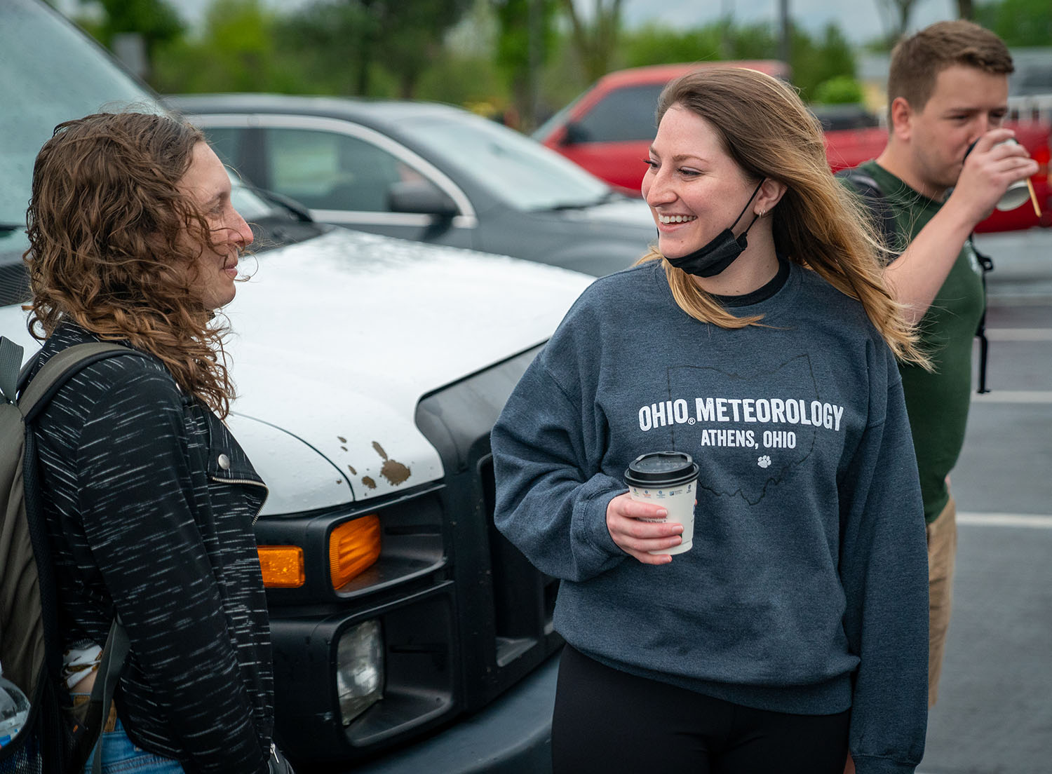 Meteorology students Eden Koval, Darby Johnson and Chris Ford chat before heading out for storm chasing.