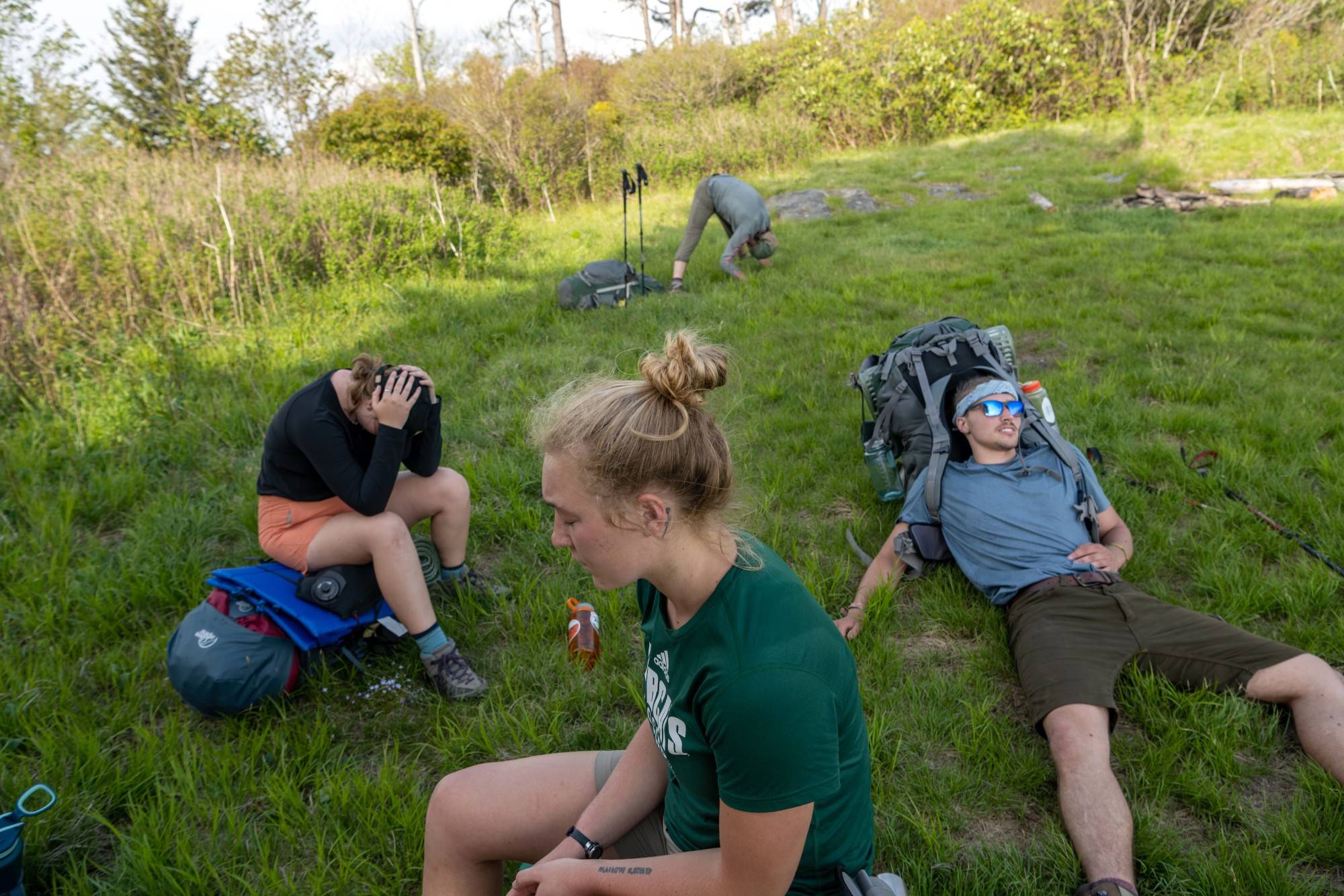 Students take a 15-minute break at the end of a long day of hiking.